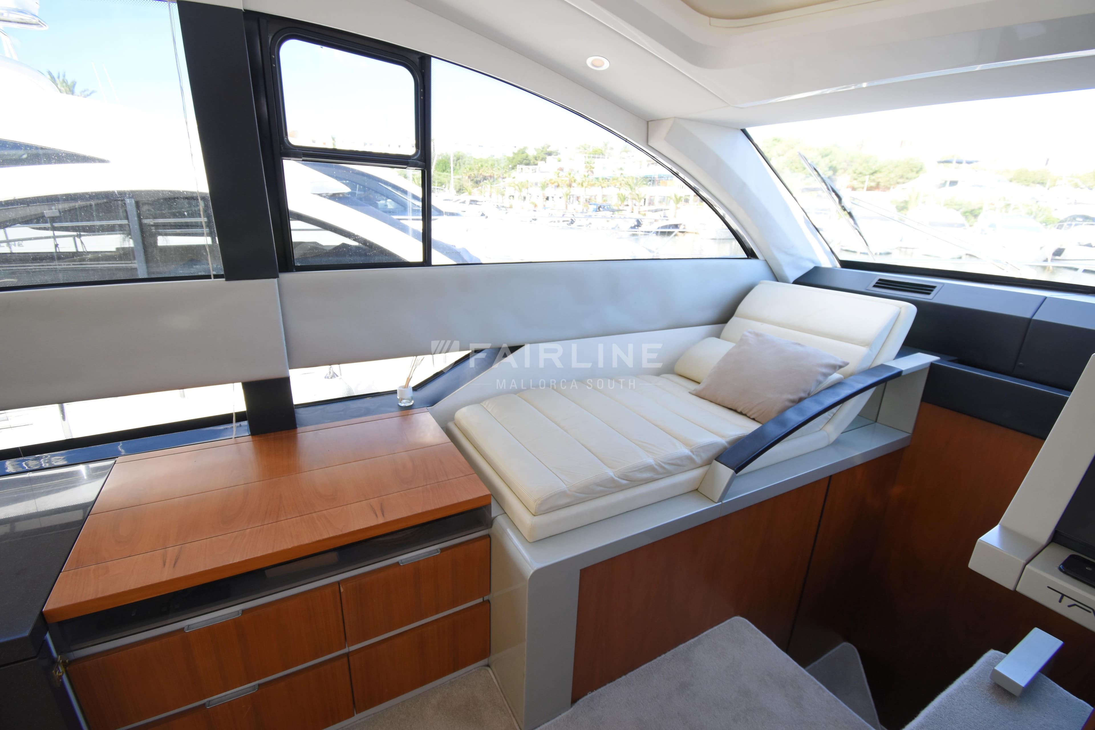 Interior of 2012 Fairline Targa 50 GT yacht with modern seating and wooden cabinetry.