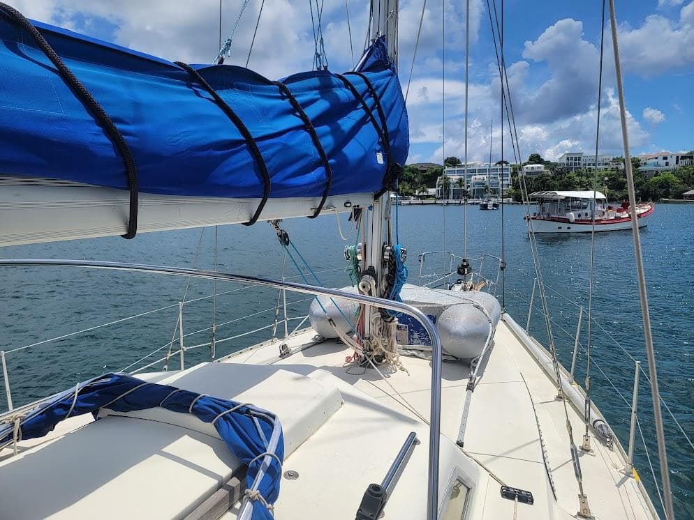 Sailboat deck view, Simpson Custom Andrew Simpson RQC 38, 1999, with blue sail cover.