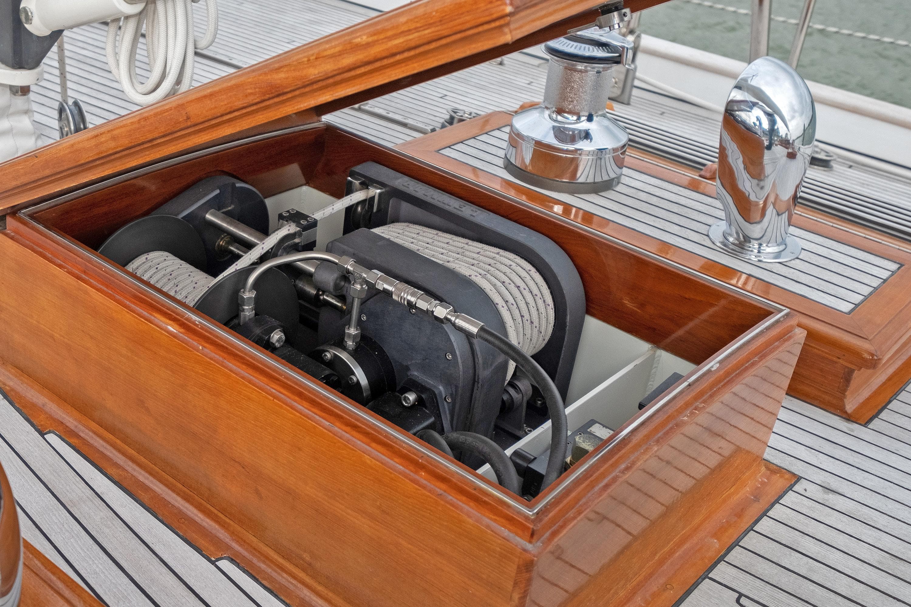 Winch system on 2004 Hoek Classic 73 yacht deck with polished wood finish.