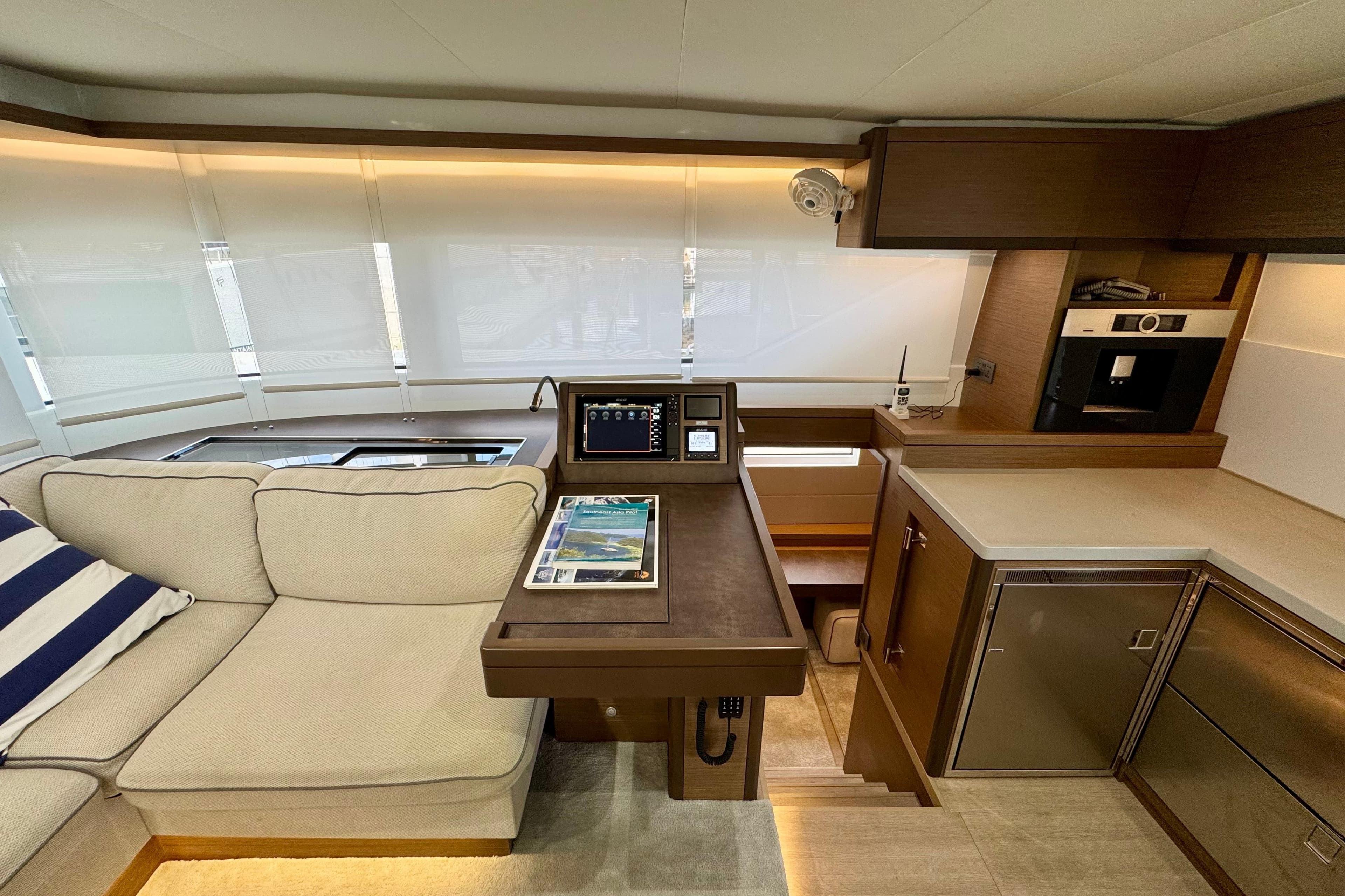 Luxurious interior of 2020 Lagoon 50 yacht with modern kitchen and cozy seating area.
