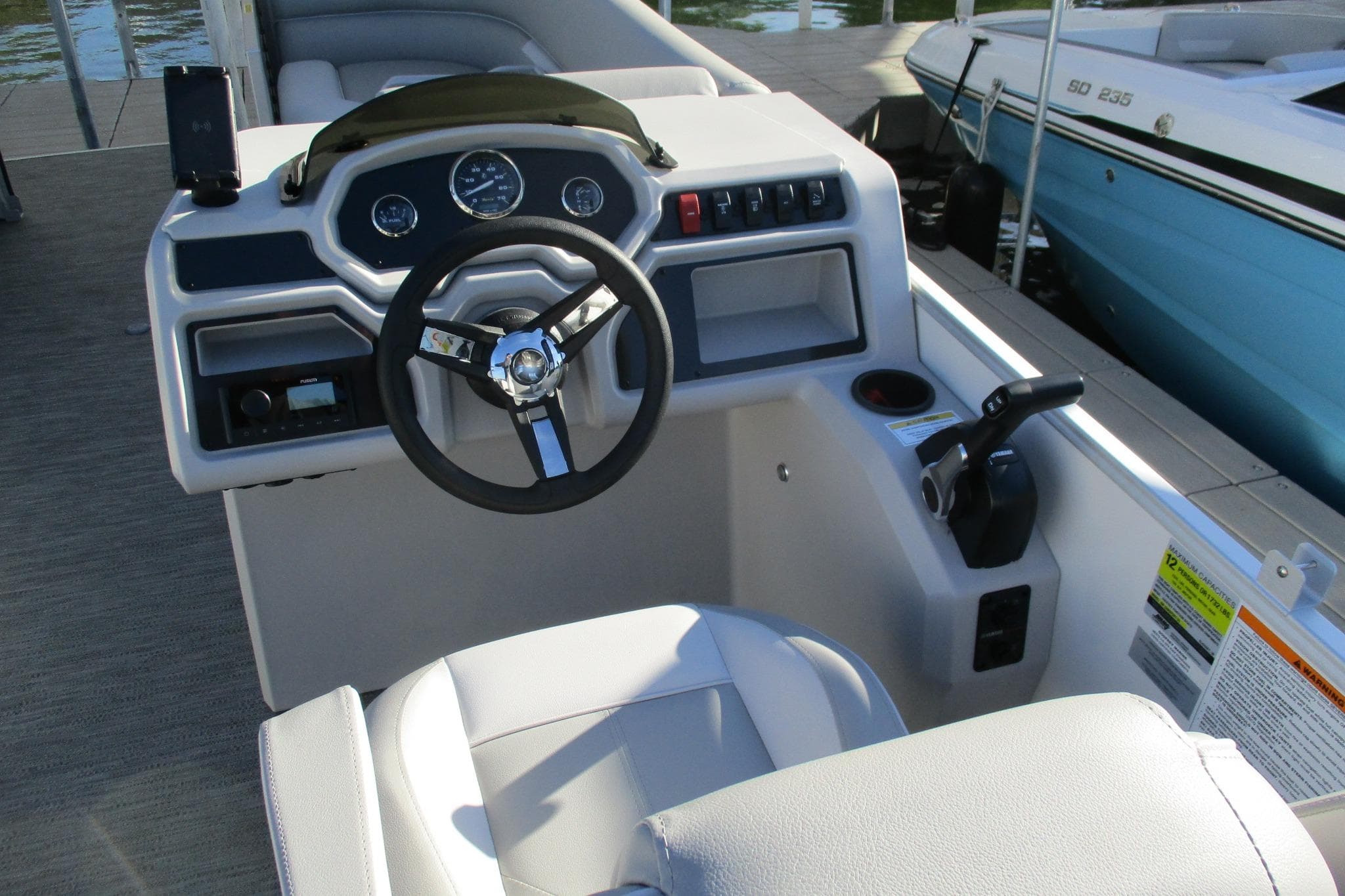 2024 Godfrey Sweetwater 2286 SBX boat helm with steering wheel and controls.