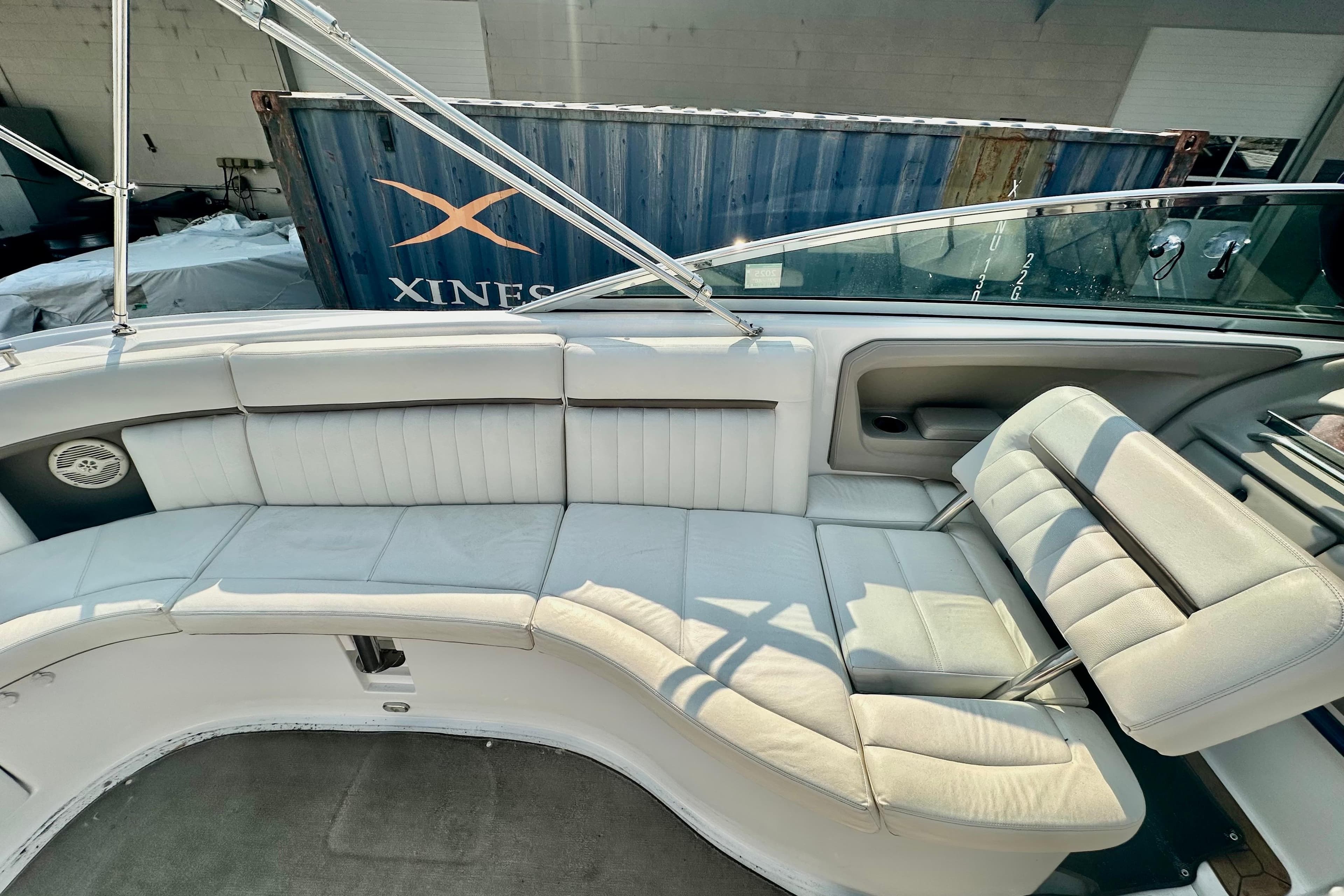 2006 Cobalt 323 boat interior with white leather seating and stainless steel railings.