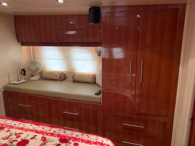 Luxurious interior of 2015 Regal 42 Sport Coupe with wooden cabinetry and cozy seating area.