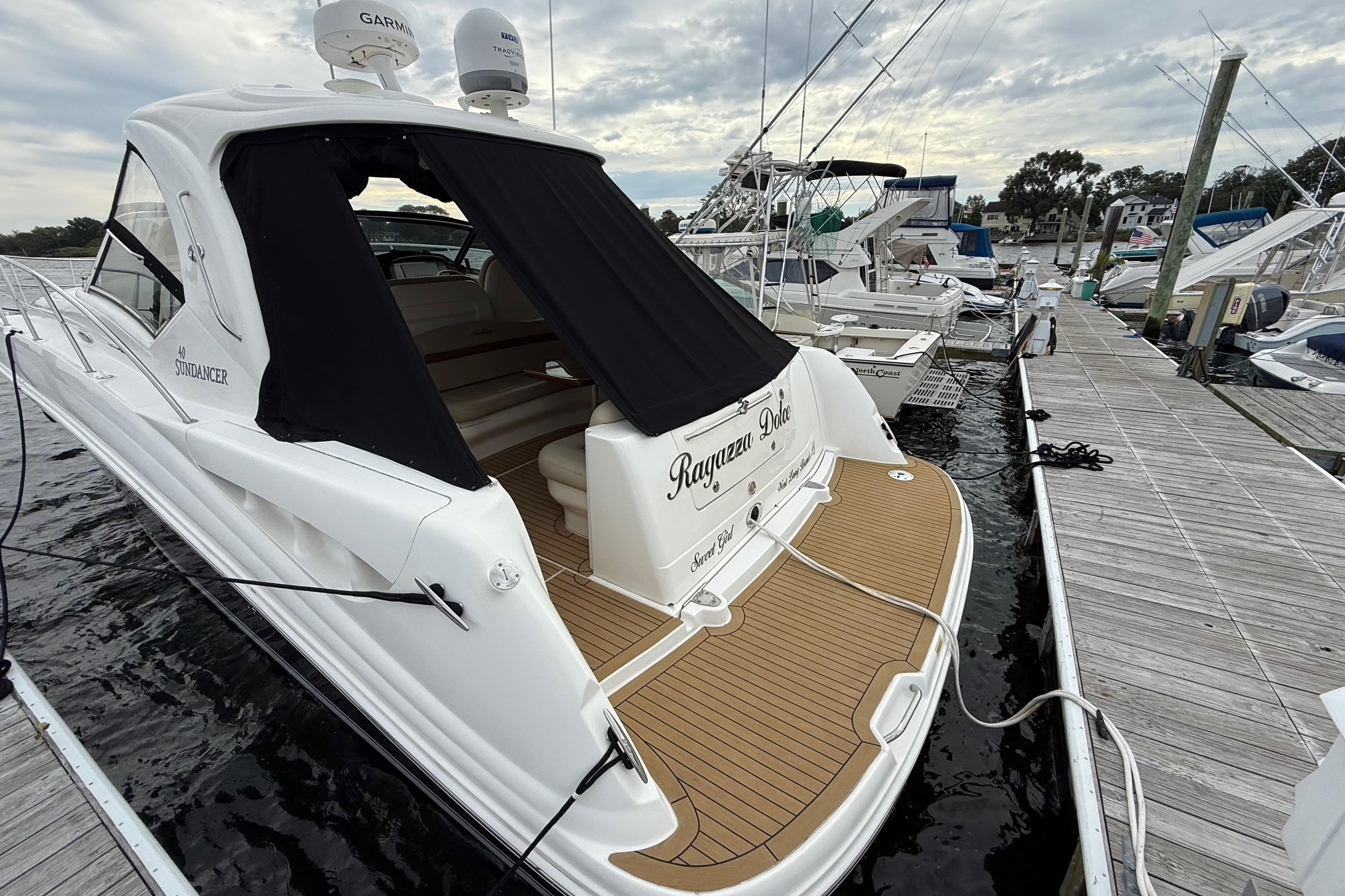 2007 Sea Ray 40 Sundancer yacht docked at marina, featuring sleek design and spacious deck.