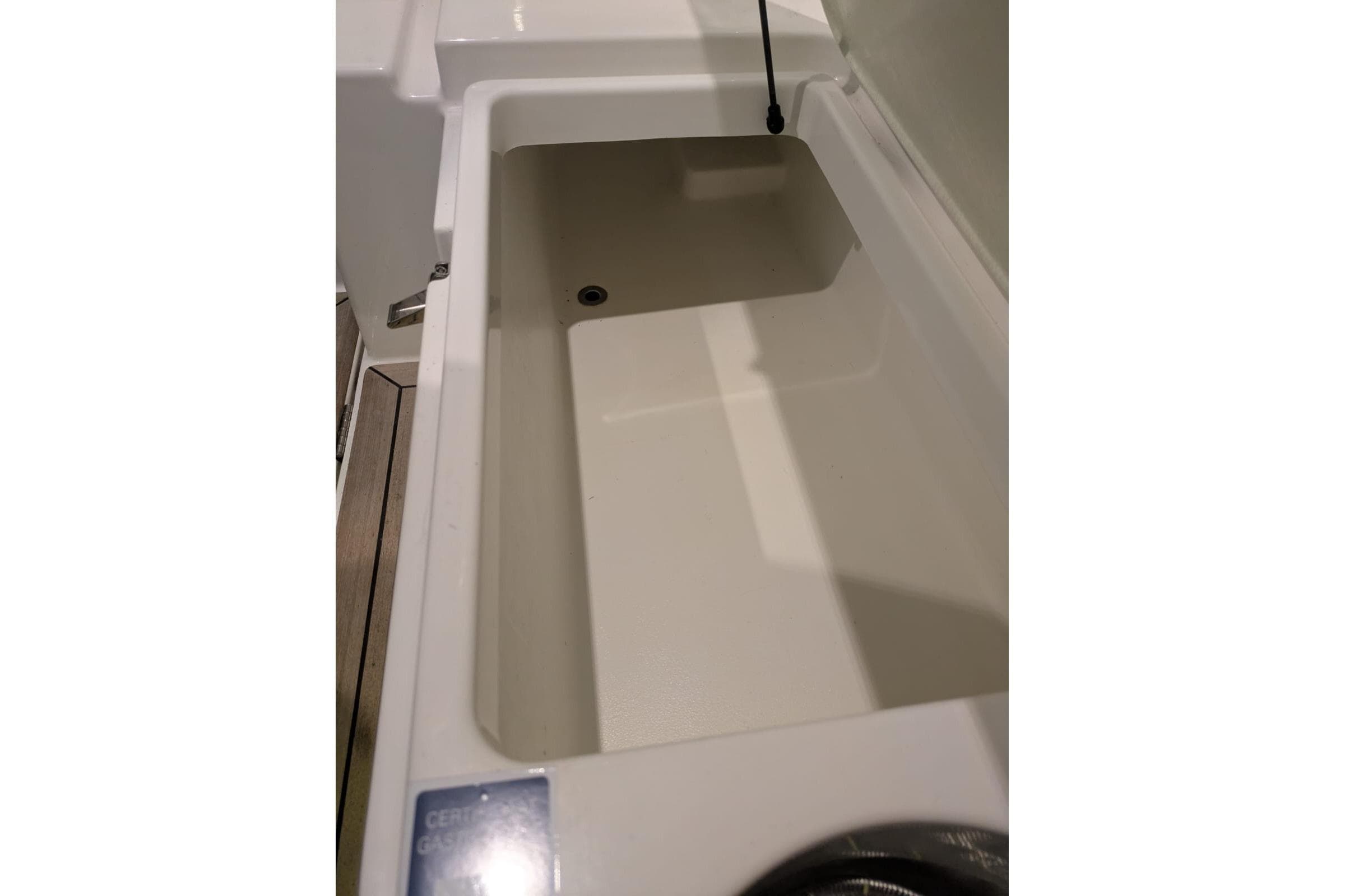 Storage compartment in 2016 Nimbus Boats 305 Coupé, showcasing spacious interior design.