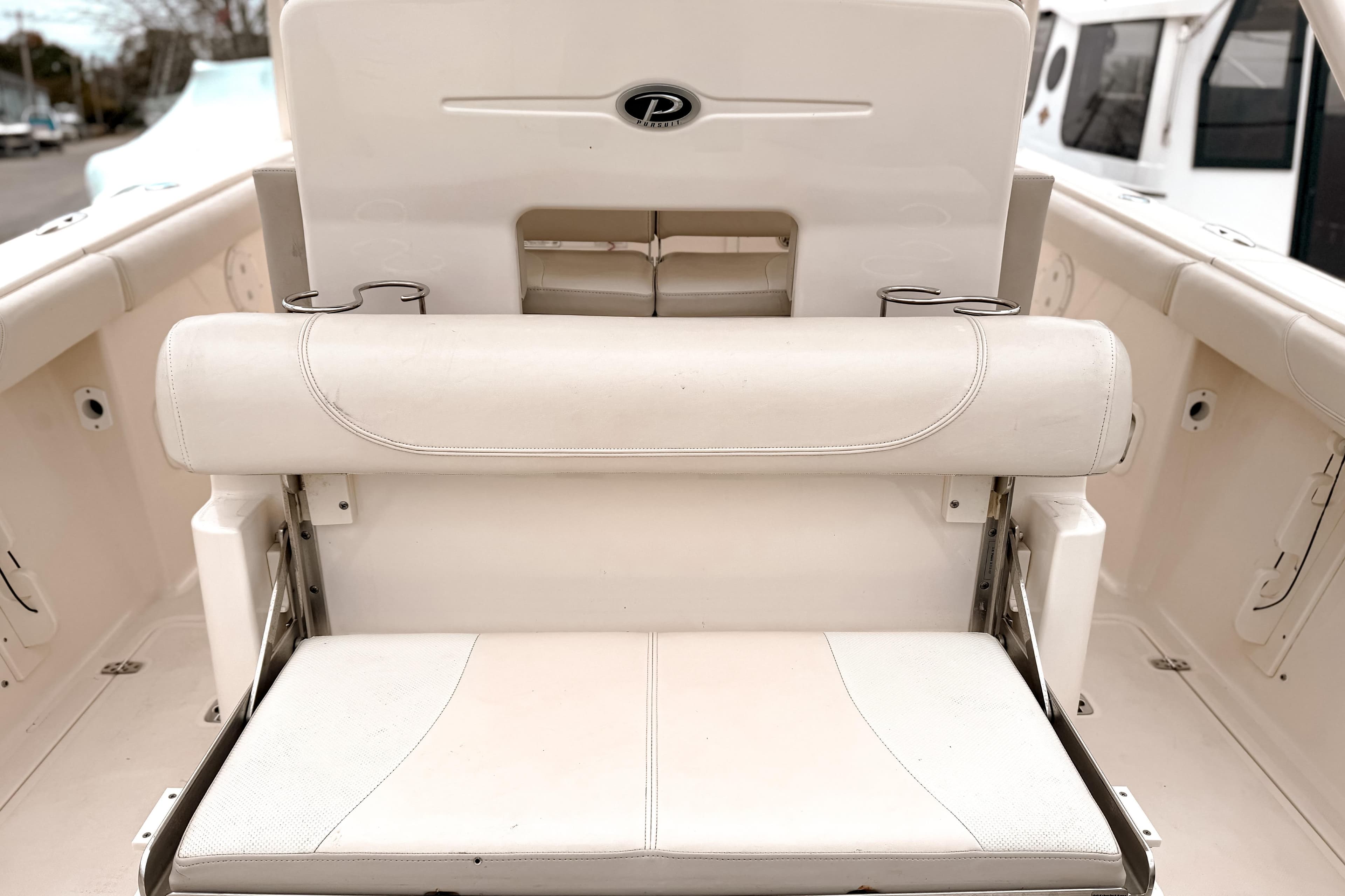 2014 Pursuit S 280 Sport boat interior with white seating and cup holders.