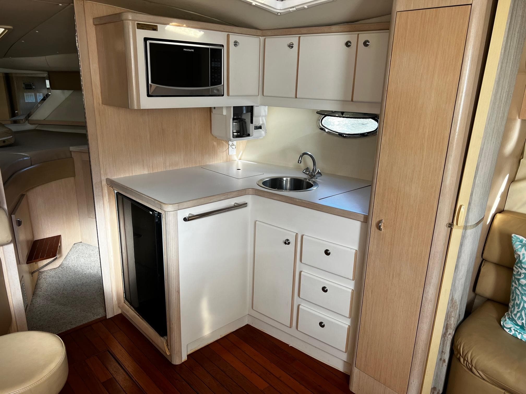 1996 Tiara Yachts 3500 Express galley with microwave, sink, and storage cabinets.