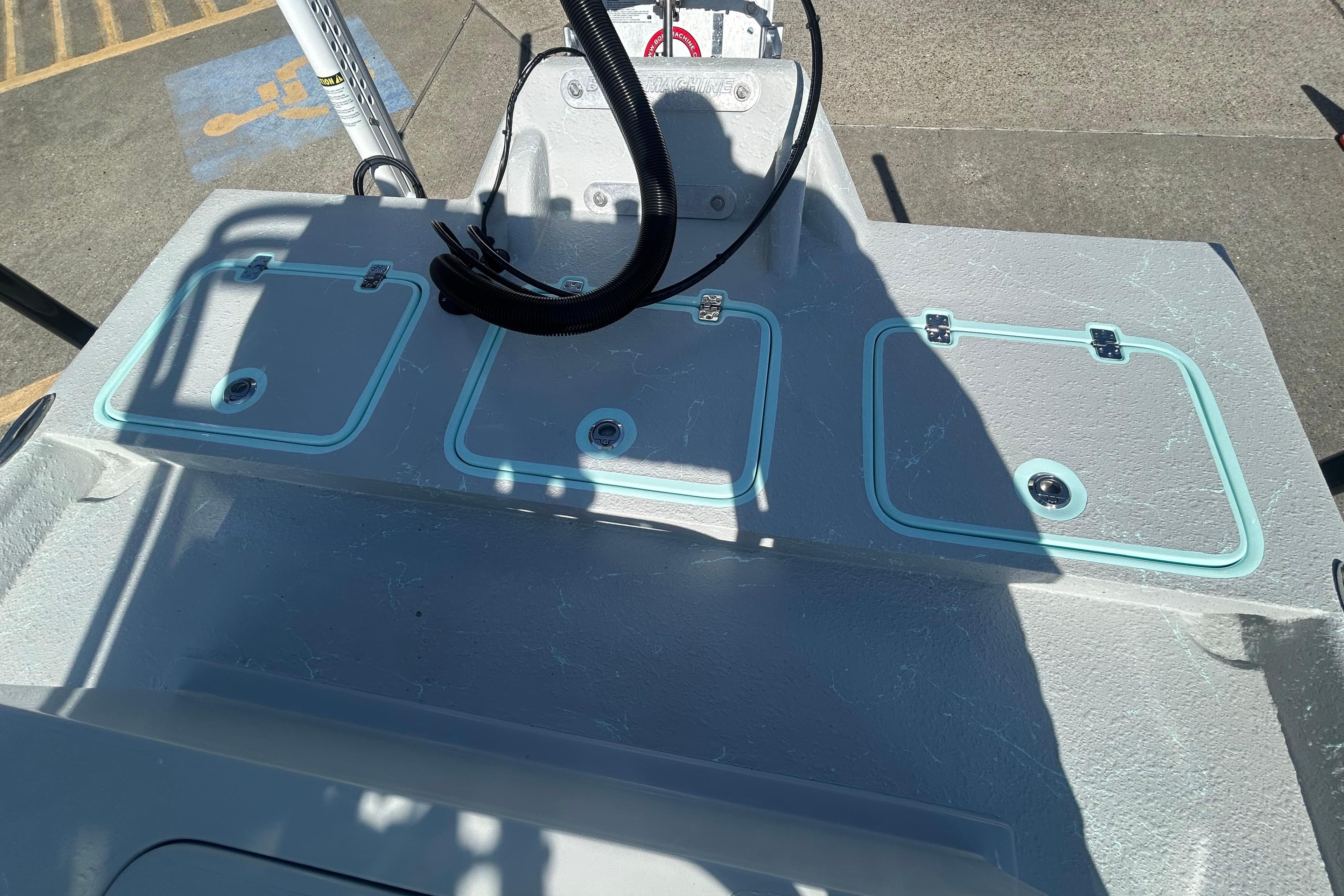 2026 Cayuco Boats Lynx 18 deck with storage compartments and control panel.