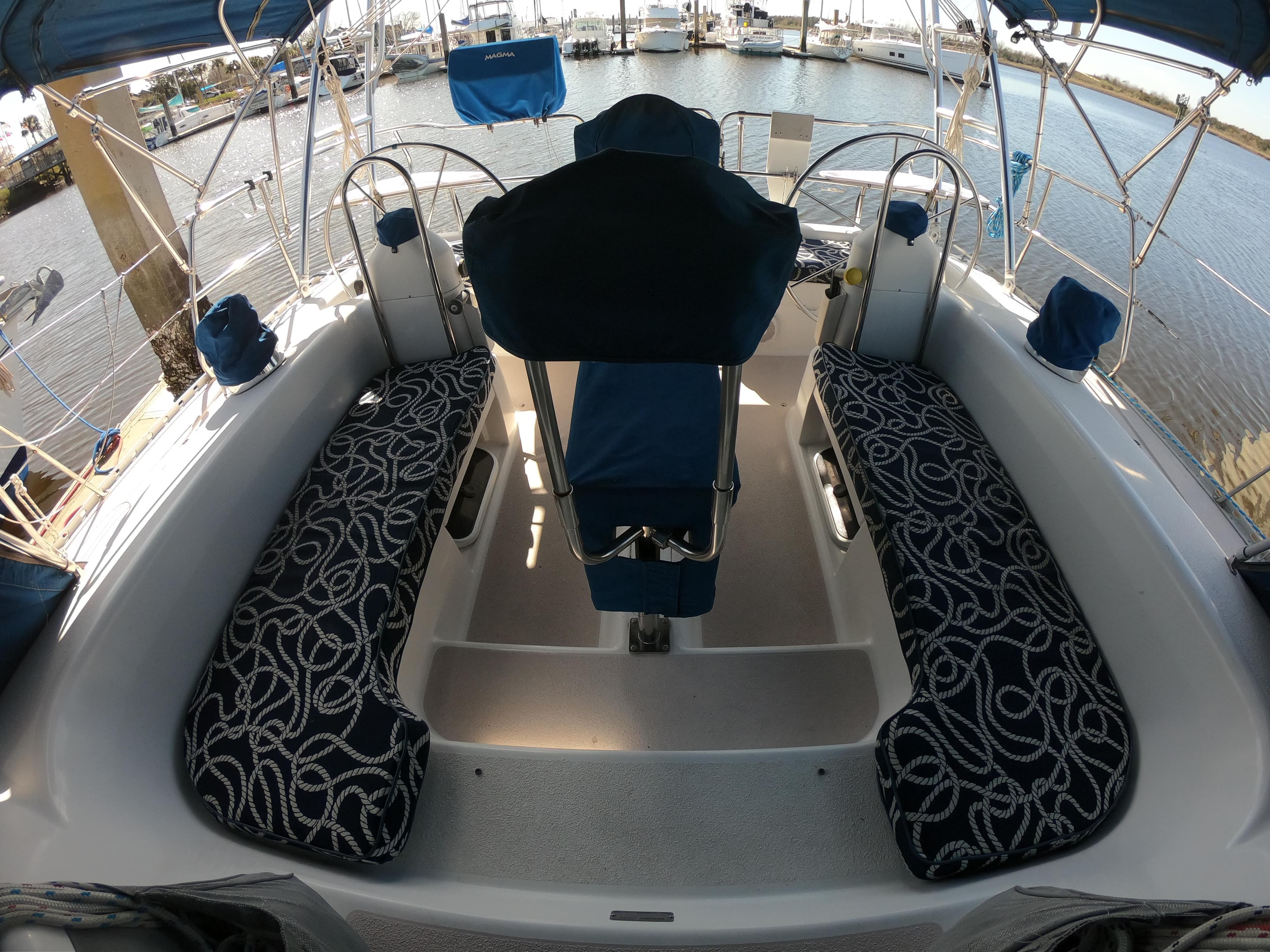 Cockpit of a 1998 Catalina 400 sailboat with patterned seating and marina view.