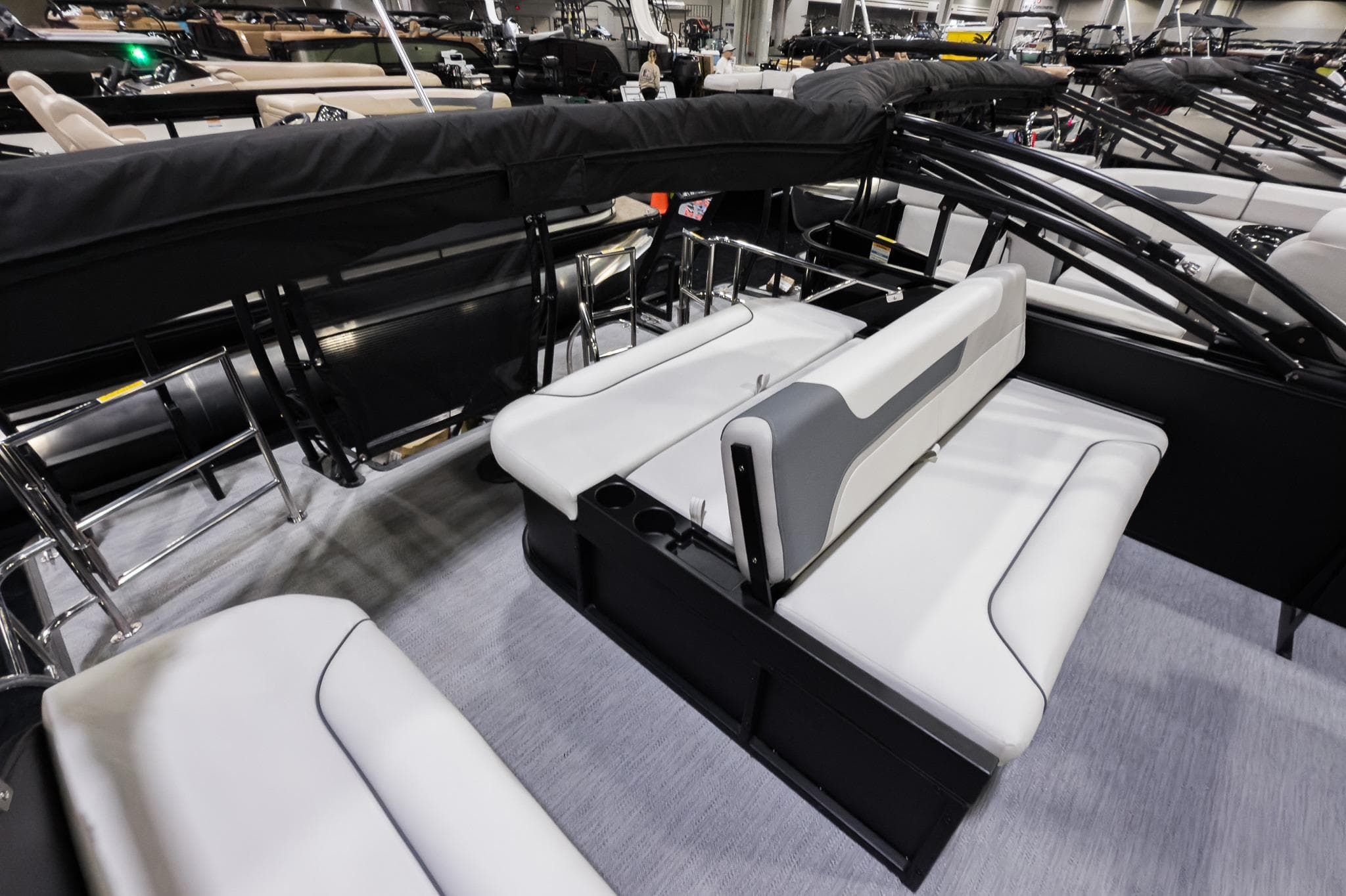 2026 Godfrey Sweetwater 22' Tritoon interior with white seating and flip lounge.