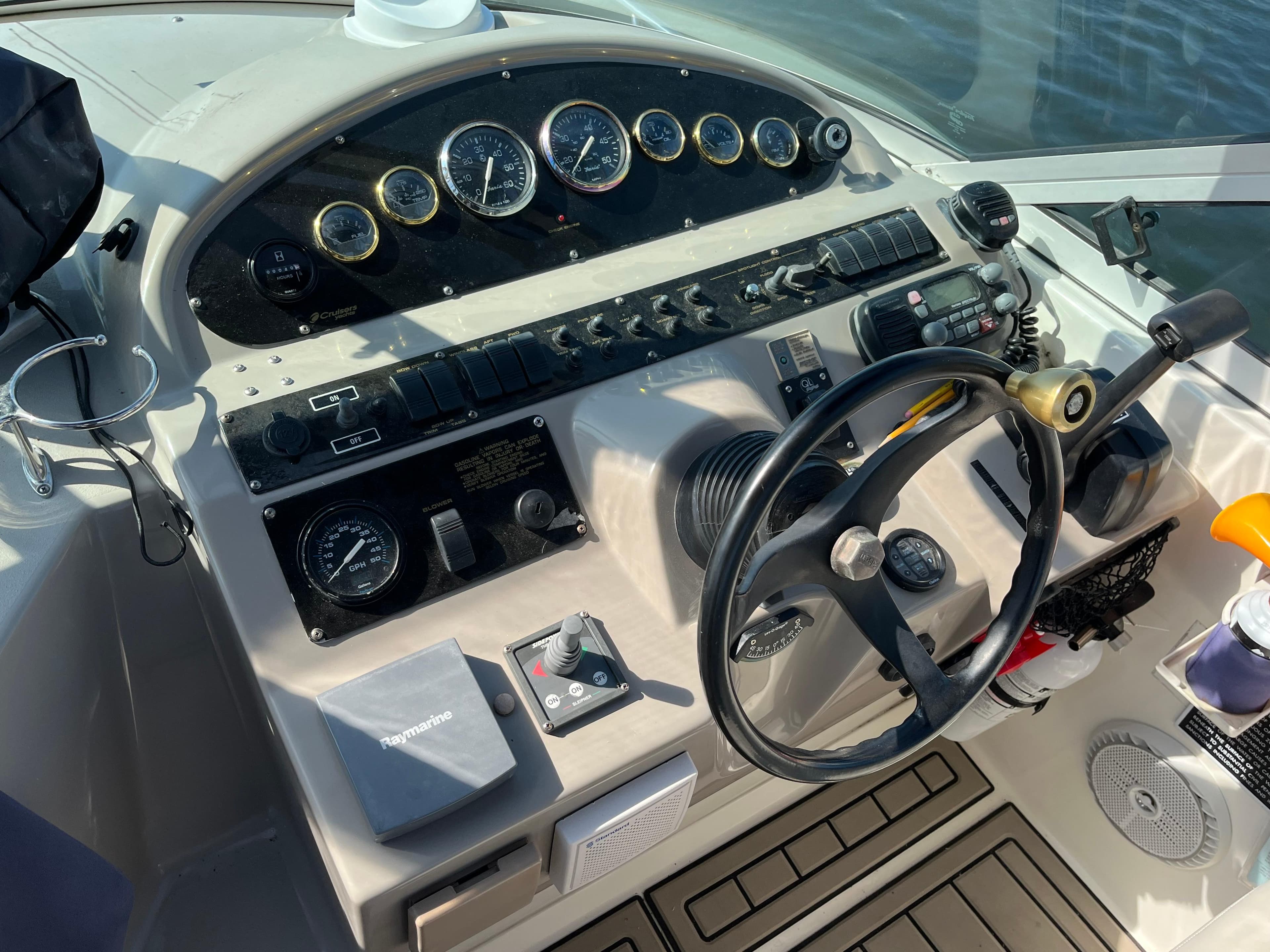 2001 Cruisers Yachts 2870 Express helm with gauges and steering wheel.