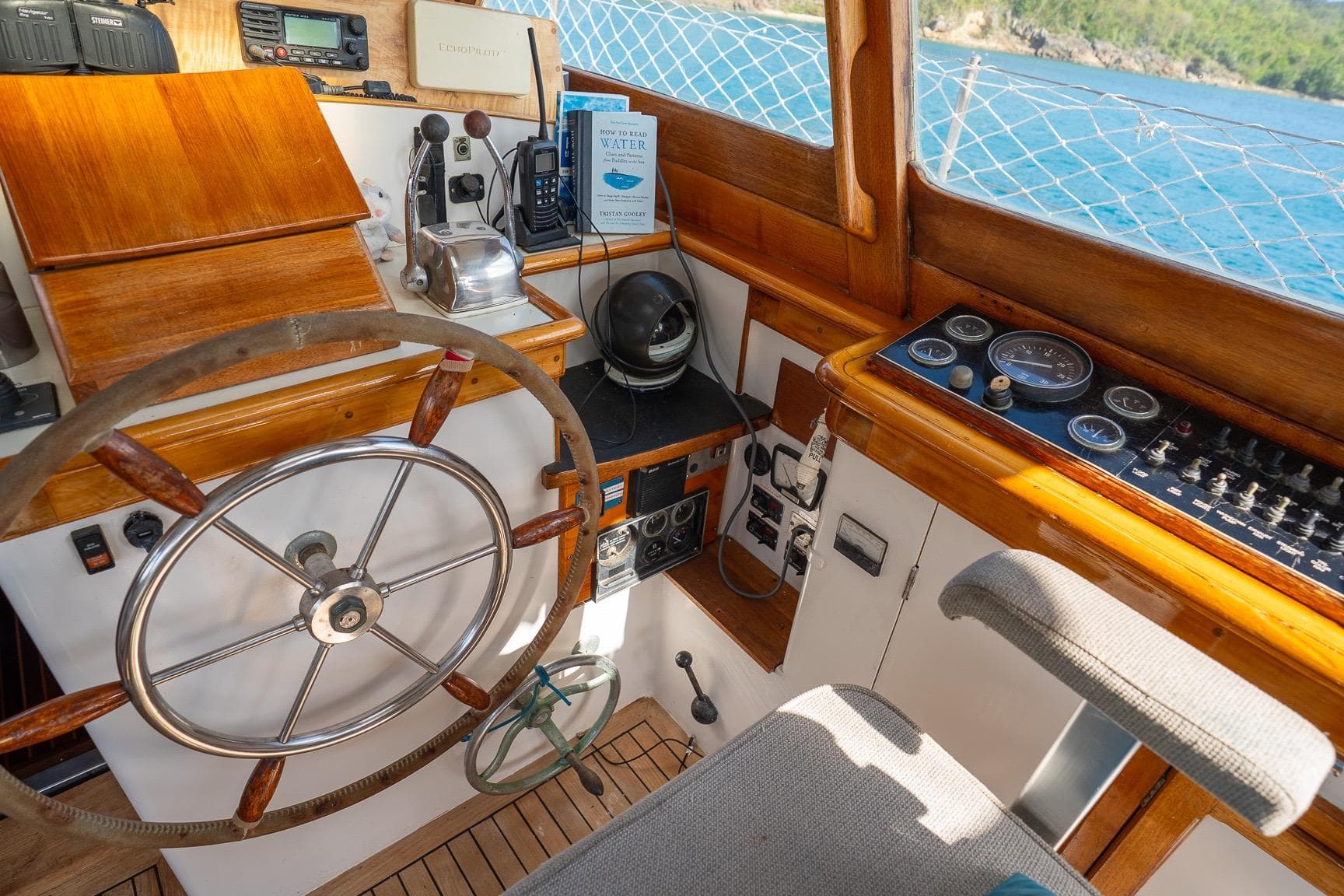Vintage 1973 Alan Wright Custom 65 yacht helm with wooden accents and nautical instruments.