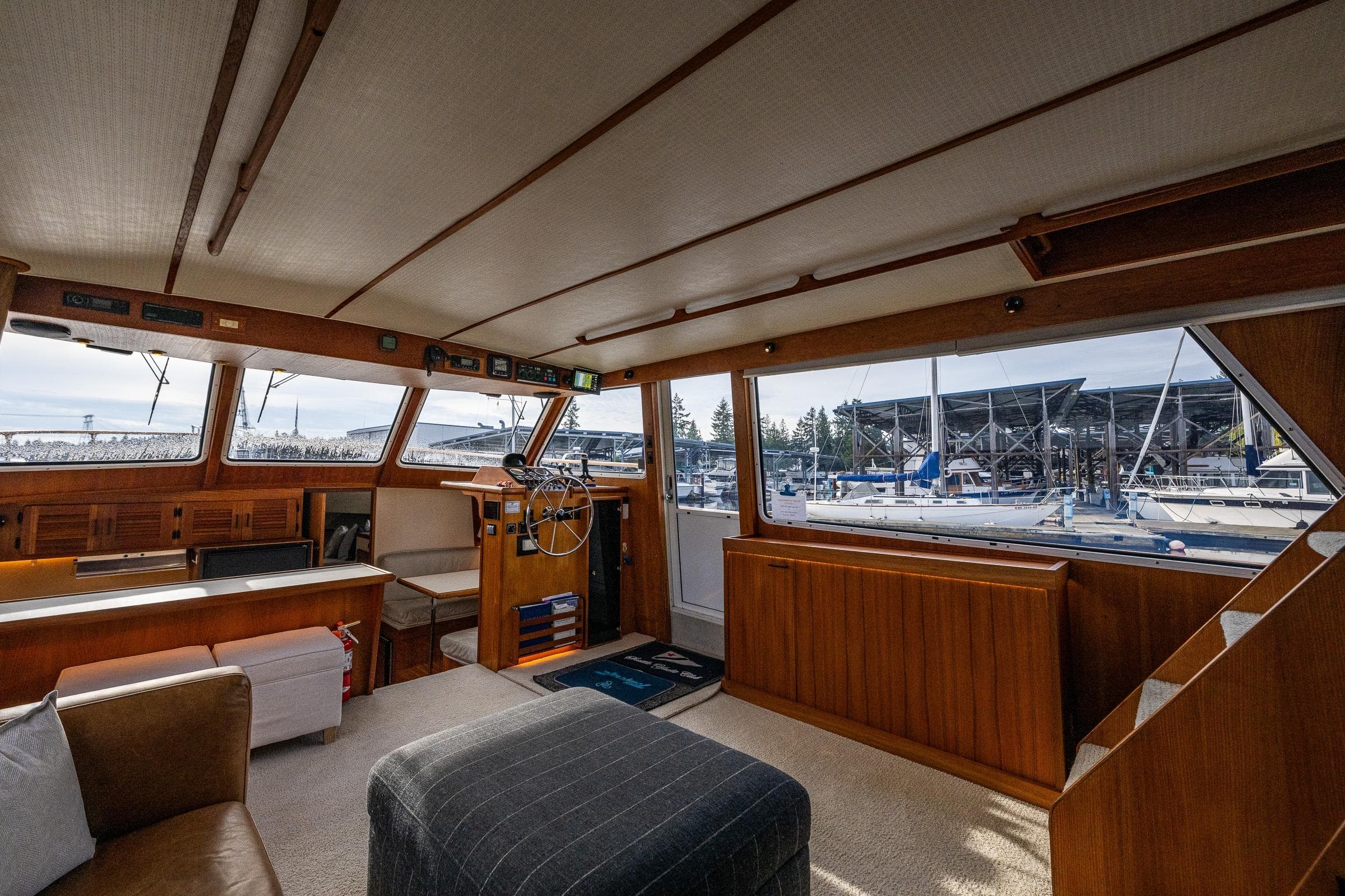 Interior of 1991 Tollycraft 48 Cockpit Motor Yacht with marina view.