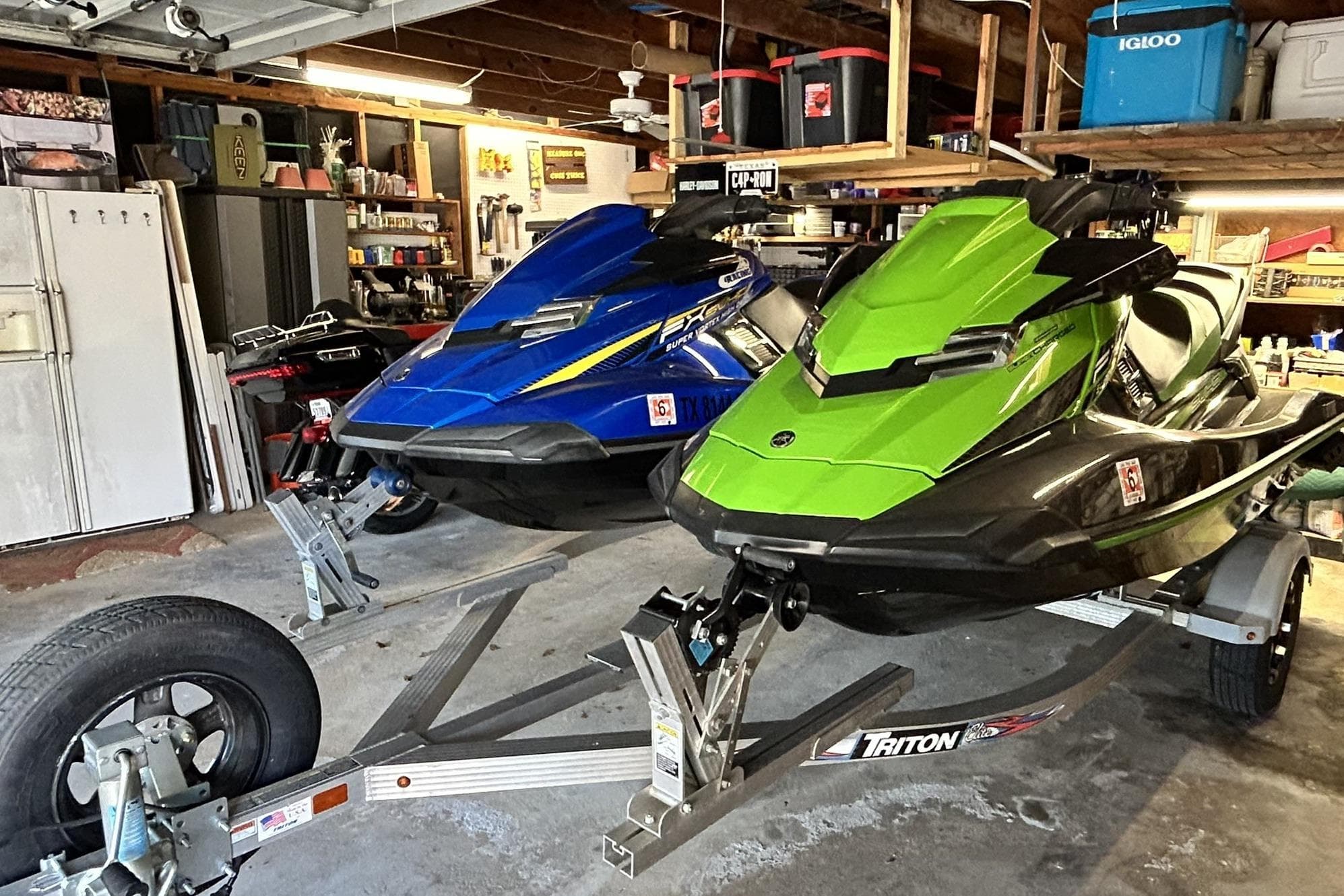 2017 Yamaha WaveRunner FX Cruiser SVHO jet skis in garage on trailer.