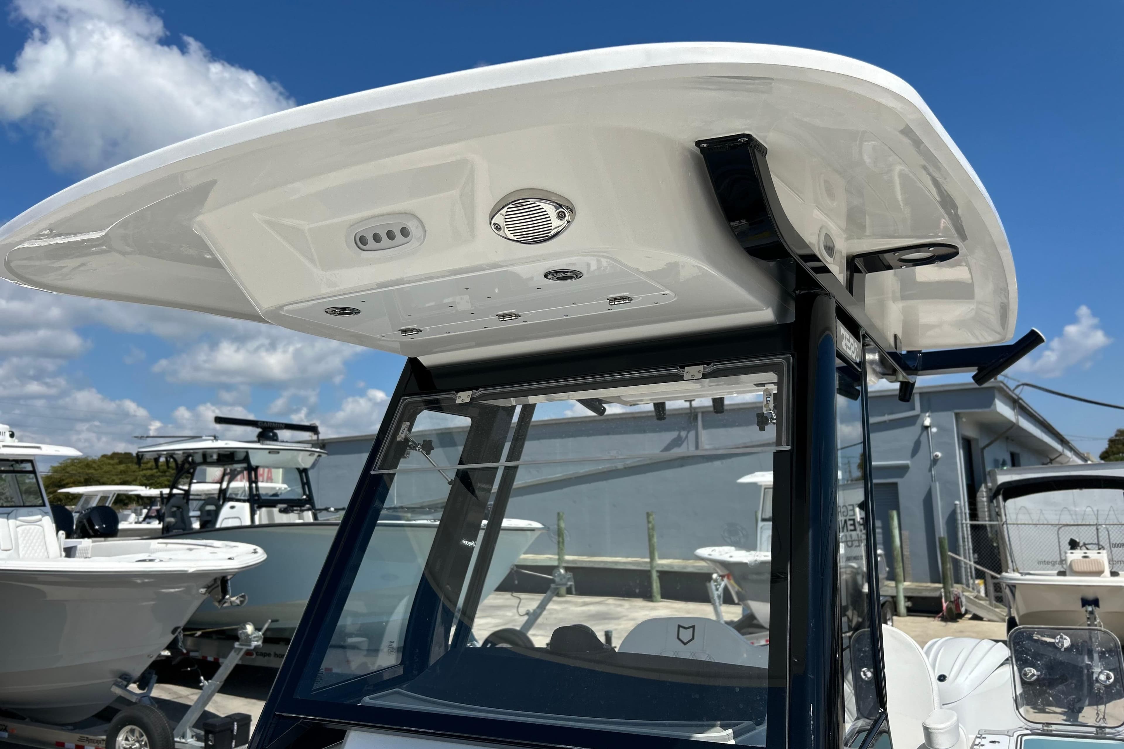 2026 Sea Fox 268 Commander boat with T-top and console, under a clear blue sky.