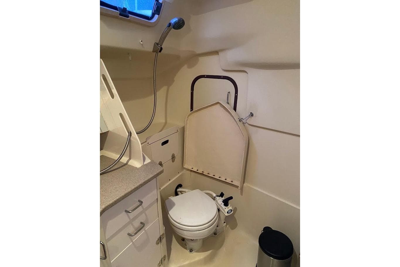 Compact bathroom in 2000 Hunter 340 sailboat with shower and toilet.