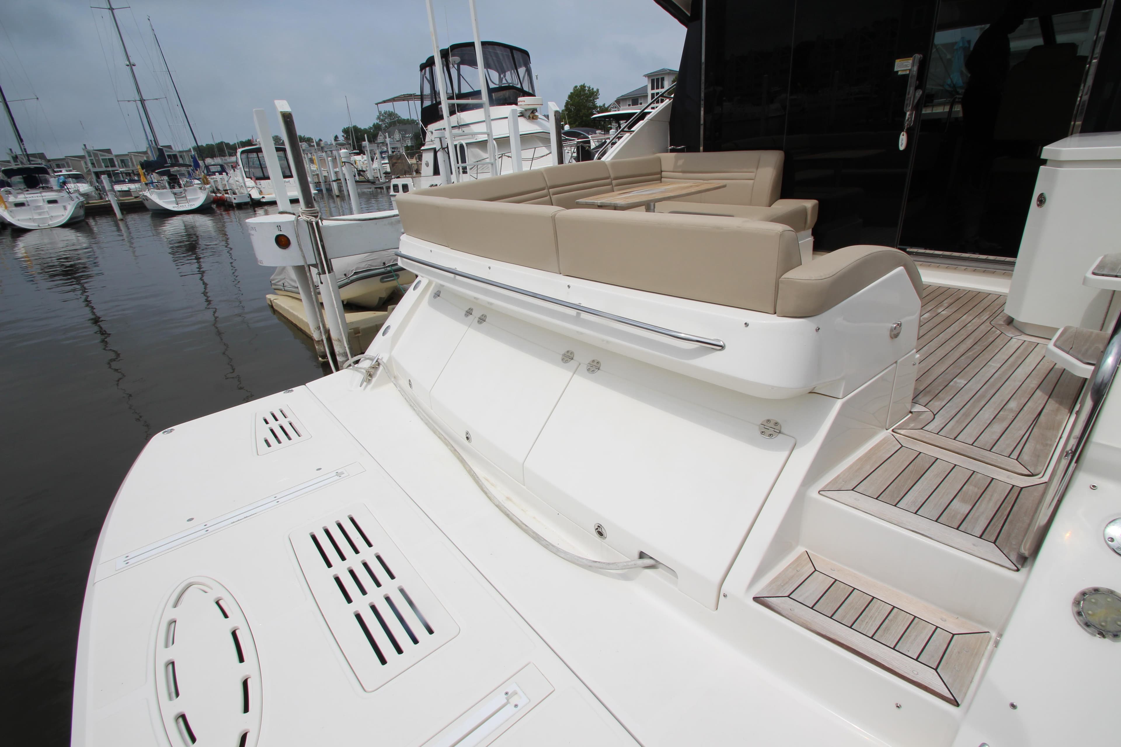 2016 Sea Ray 510 Sundancer yacht with spacious deck and seating at marina.