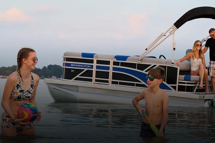 Family enjoying water beside Bennington 23 S-One Swingback 2026.