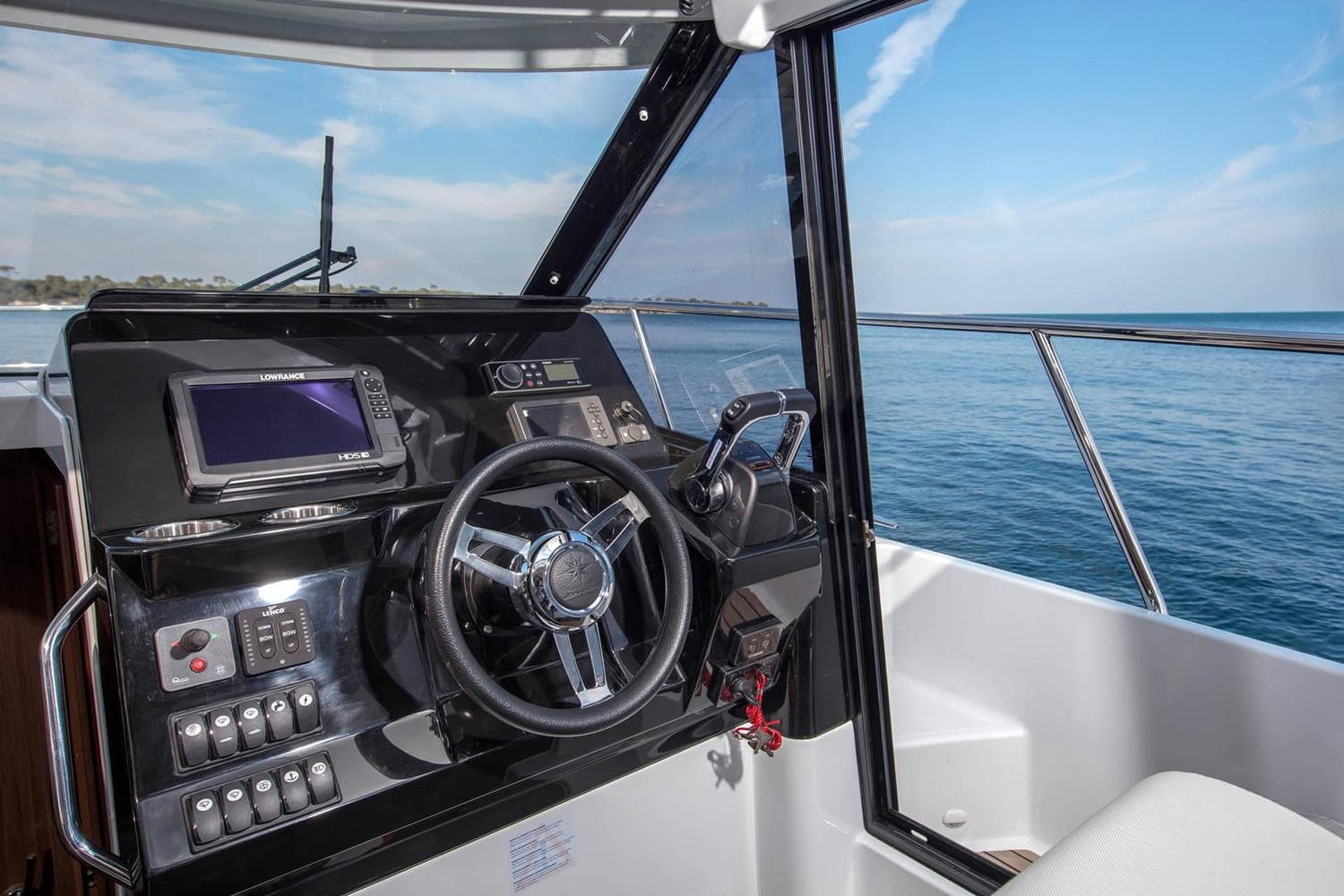 Manufacturer Provided Image: 2020 Jeanneau NC 1095 boat helm with navigation system and ocean view.