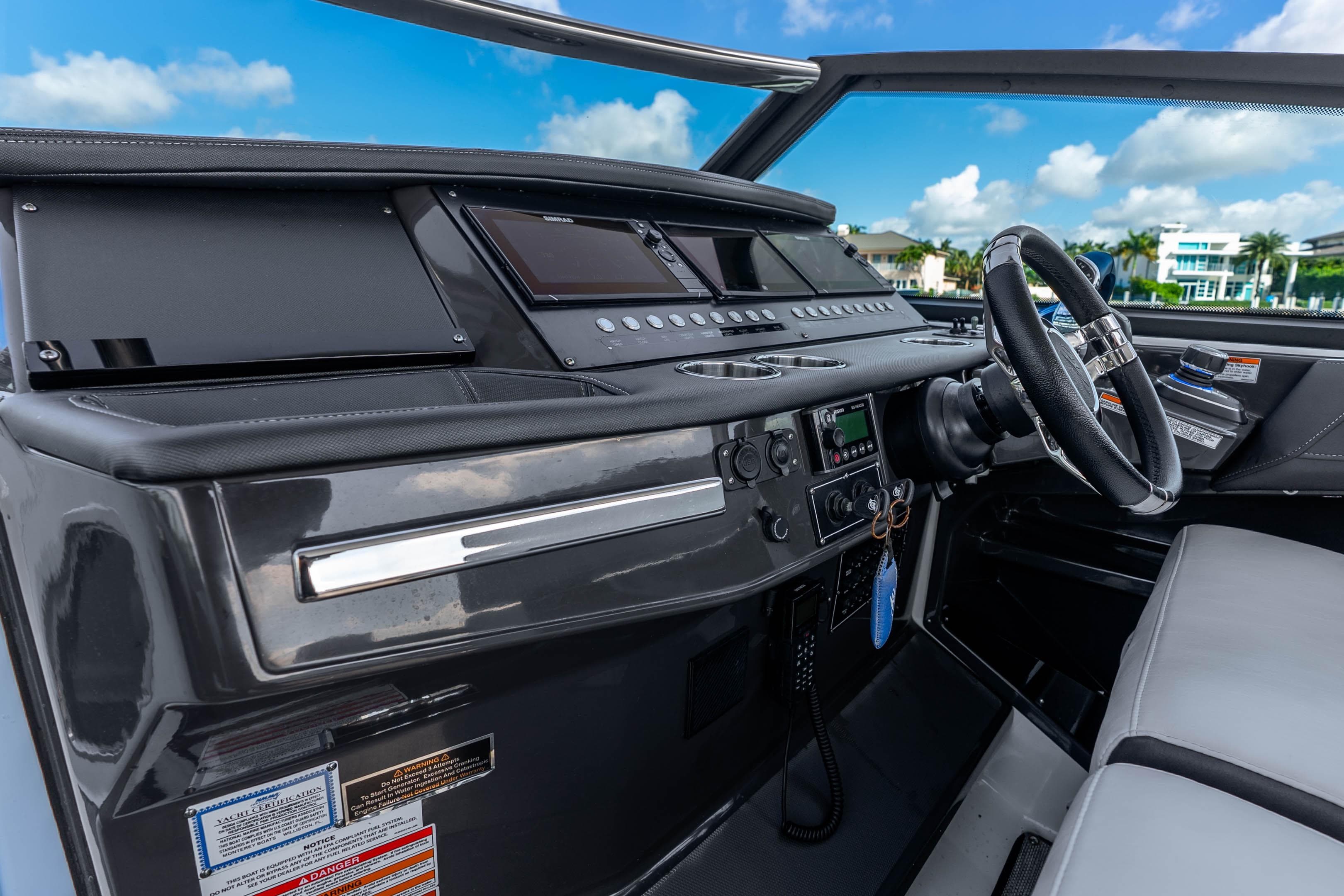 Cockpit of 2022 Monterey 378SS Super Sport boat with modern controls and steering wheel.
