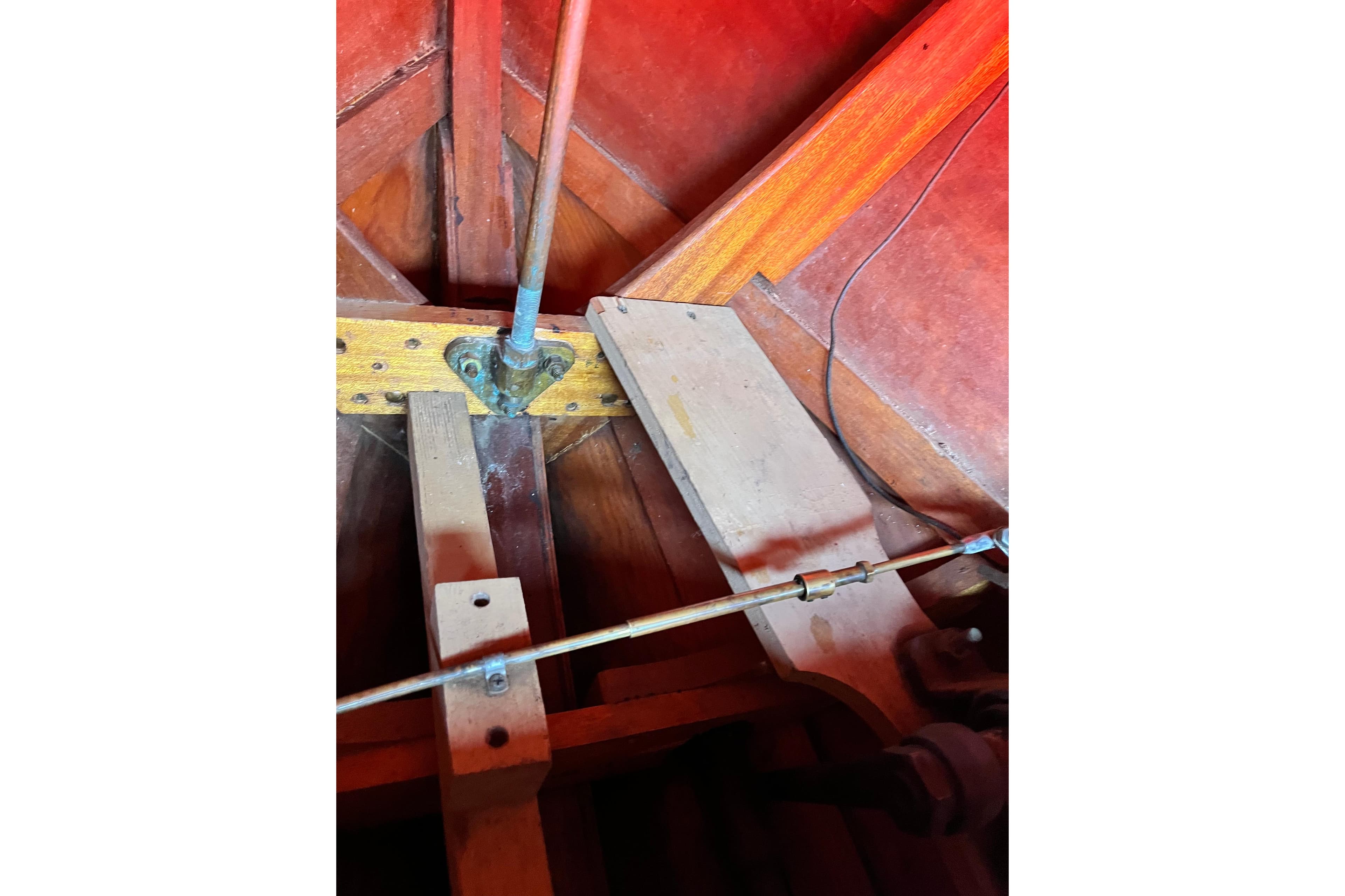 1958 Chris-Craft 16 Cavalier interior, showcasing wooden structure and mechanical components.