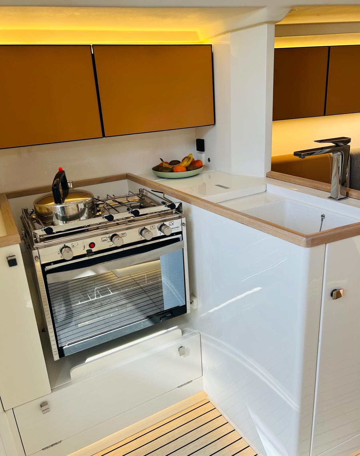 Modern yacht kitchen with stove, sink, and cabinets in Italia Yachts IY 11.98, 2023 model.
