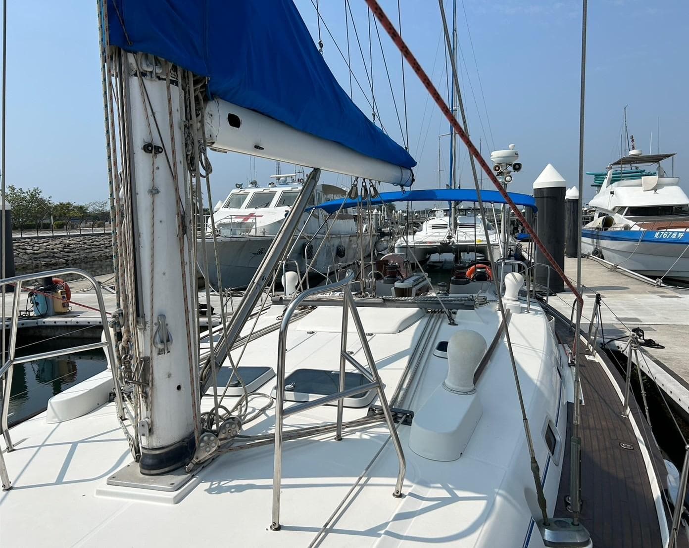 Beneteau Oceanis 50 sailboat docked at marina, 1997 model, with blue sail cover.