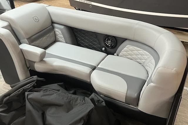 Luxurious seating in 2026 MONACO 235SFL boat with quilted upholstery and integrated speaker.