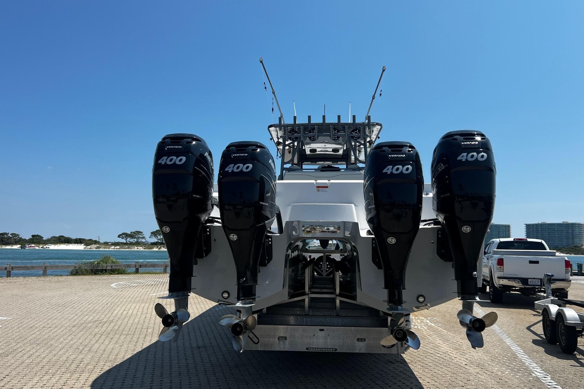 2022 Invincible 46 Catamaran with four powerful outboard engines, docked by the waterfront.