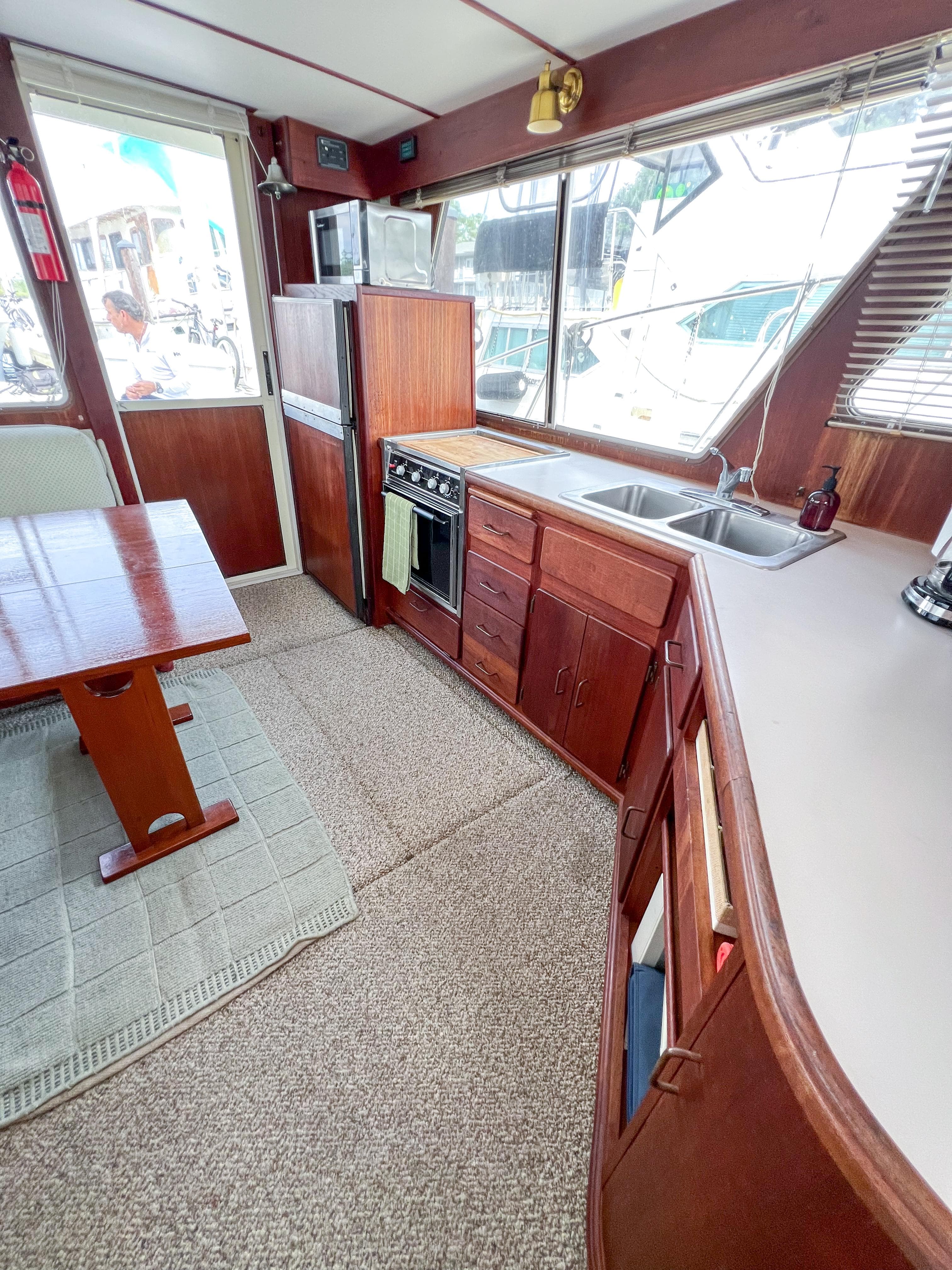 1987 Tollycraft 34 Sport Sedan interior with kitchen and dining area.