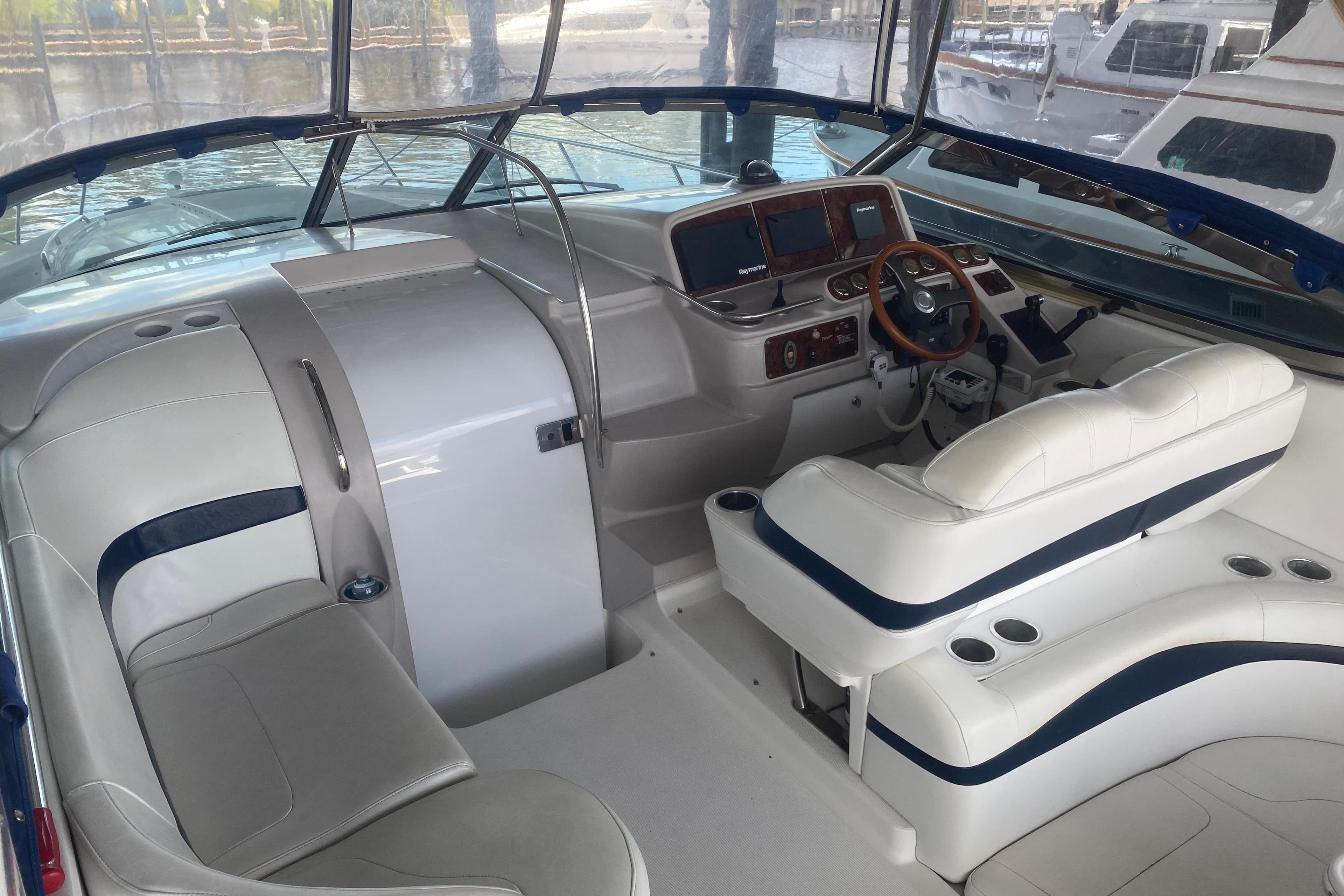 2005 Formula 37 Performance Cruiser interior with white seating and modern dashboard.
