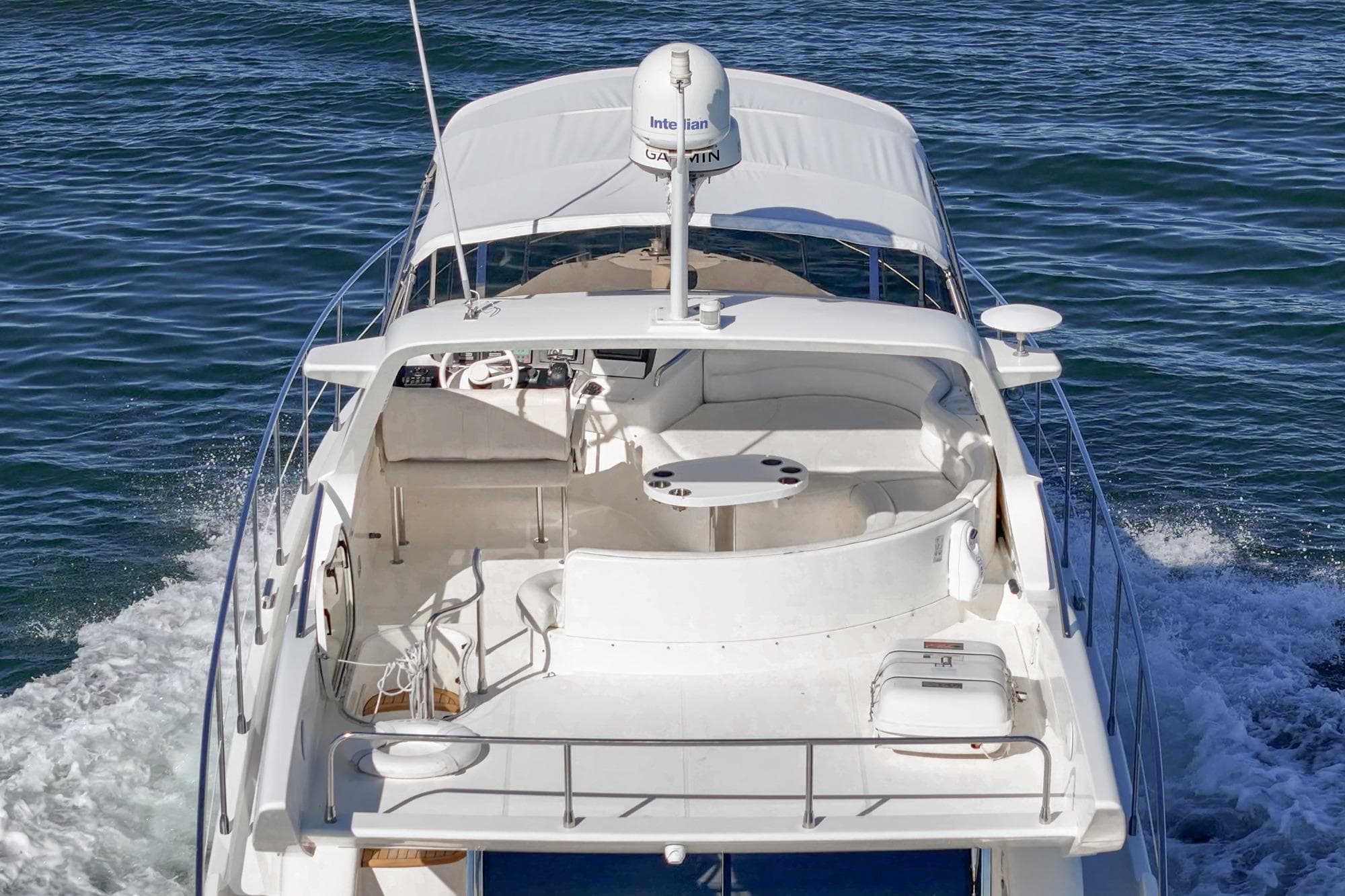 Luxurious 2002 Azimut 58 yacht cruising on open water, showcasing elegant design.