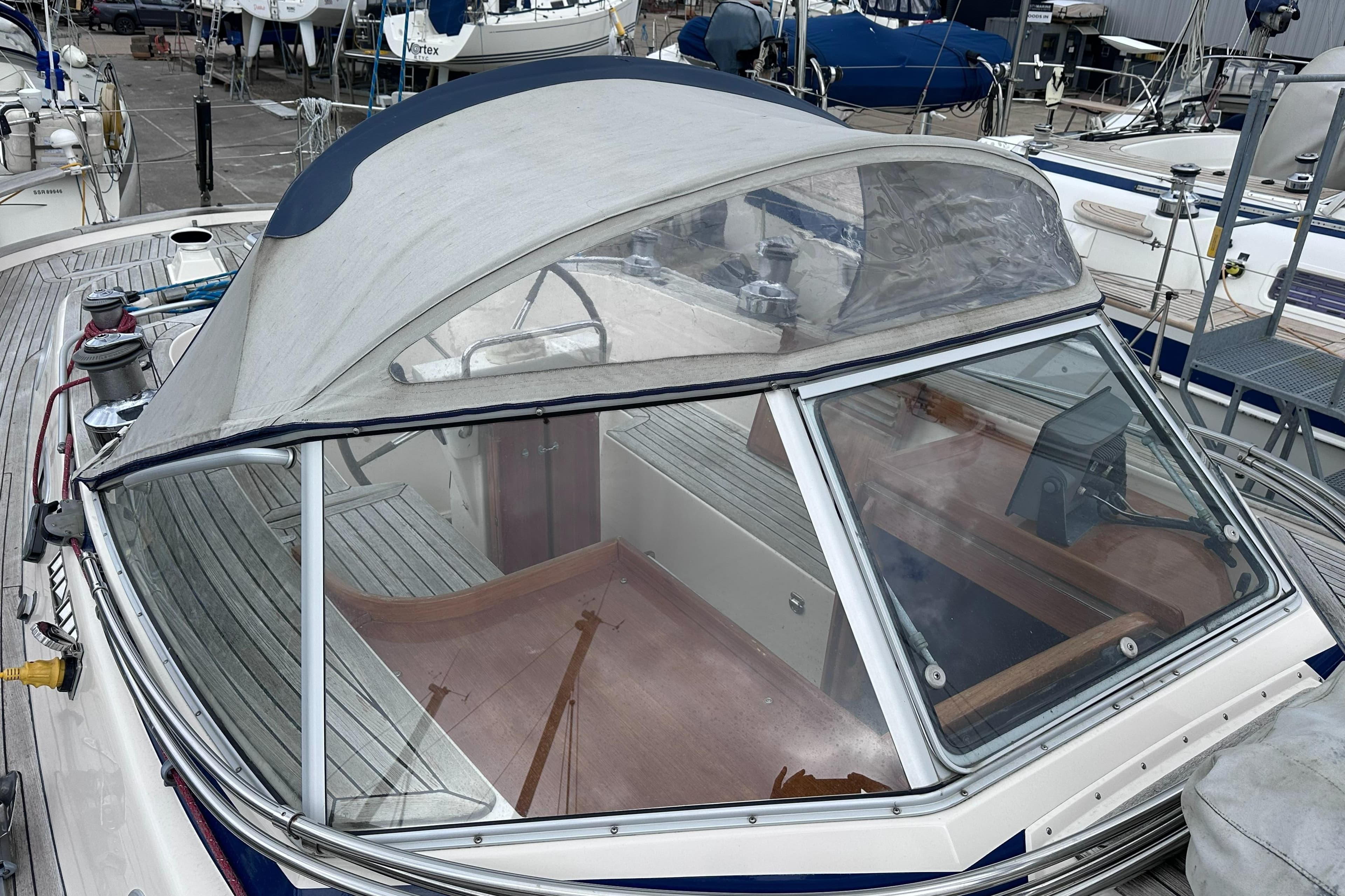 Hallberg-Rassy 46 sailboat from 2000, featuring a covered cockpit and wooden deck details.