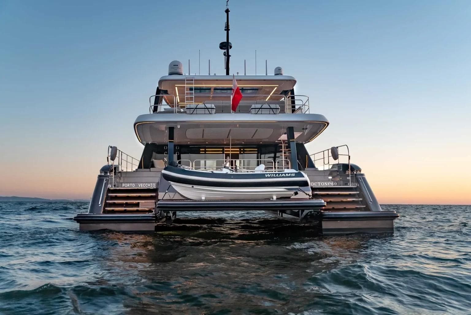 2024 Sunreef 60 Power Eco yacht at sunset, rear view on the water.