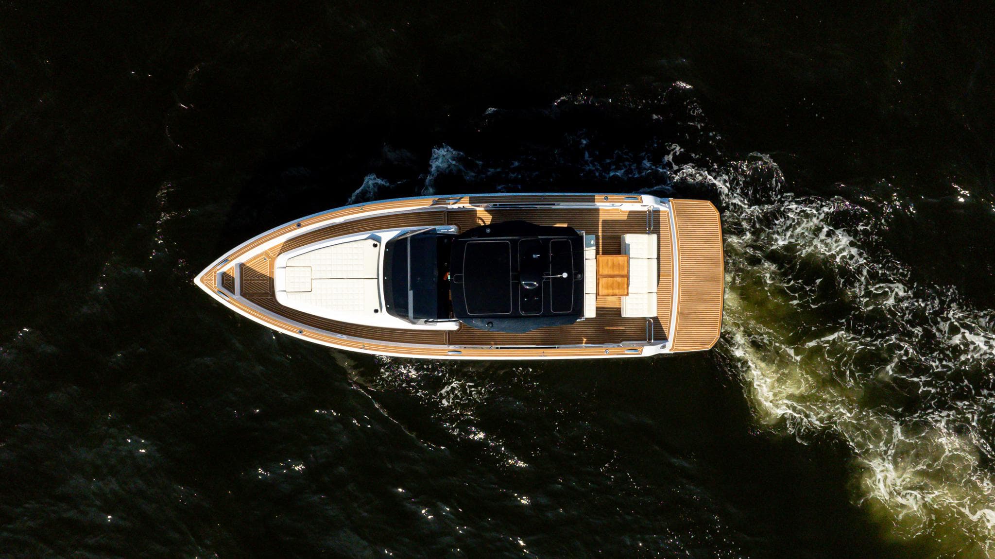 2025 Pardo Yachts 38 Walkaround cruising on dark water, aerial view.