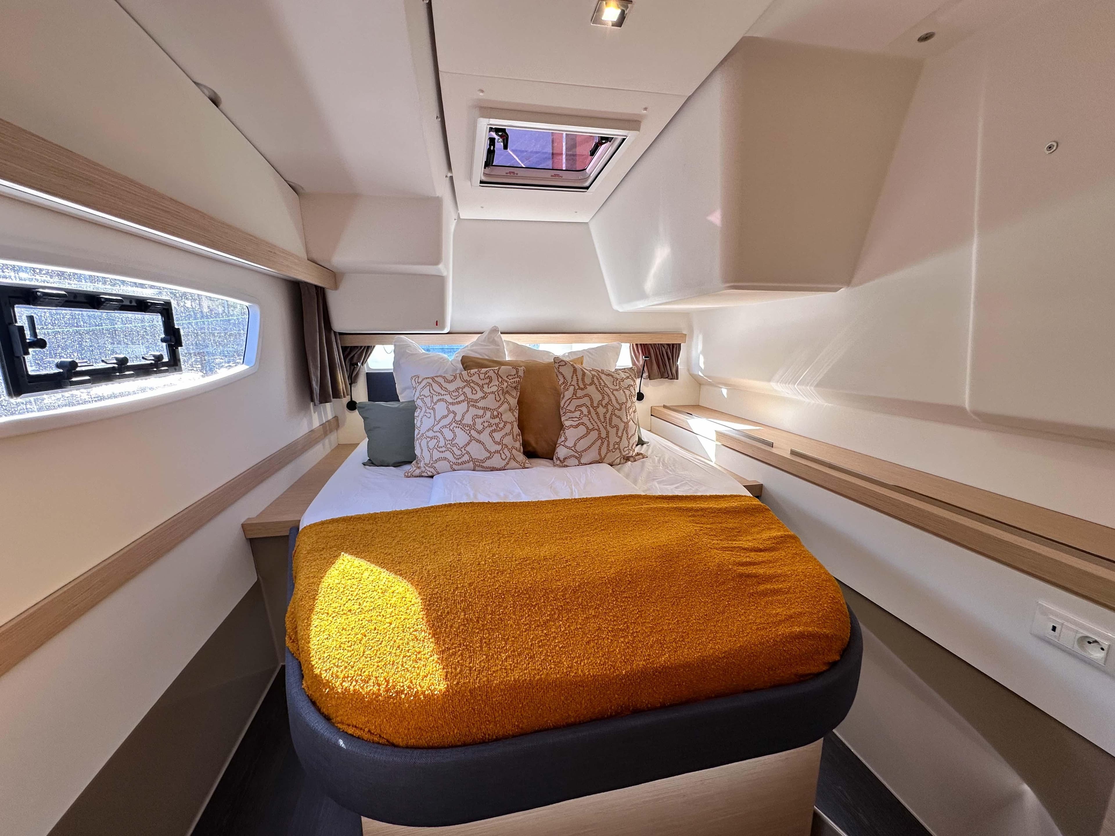 Luxurious cabin interior of 2025 Fountaine Pajot Isla 40 catamaran with cozy bedding.