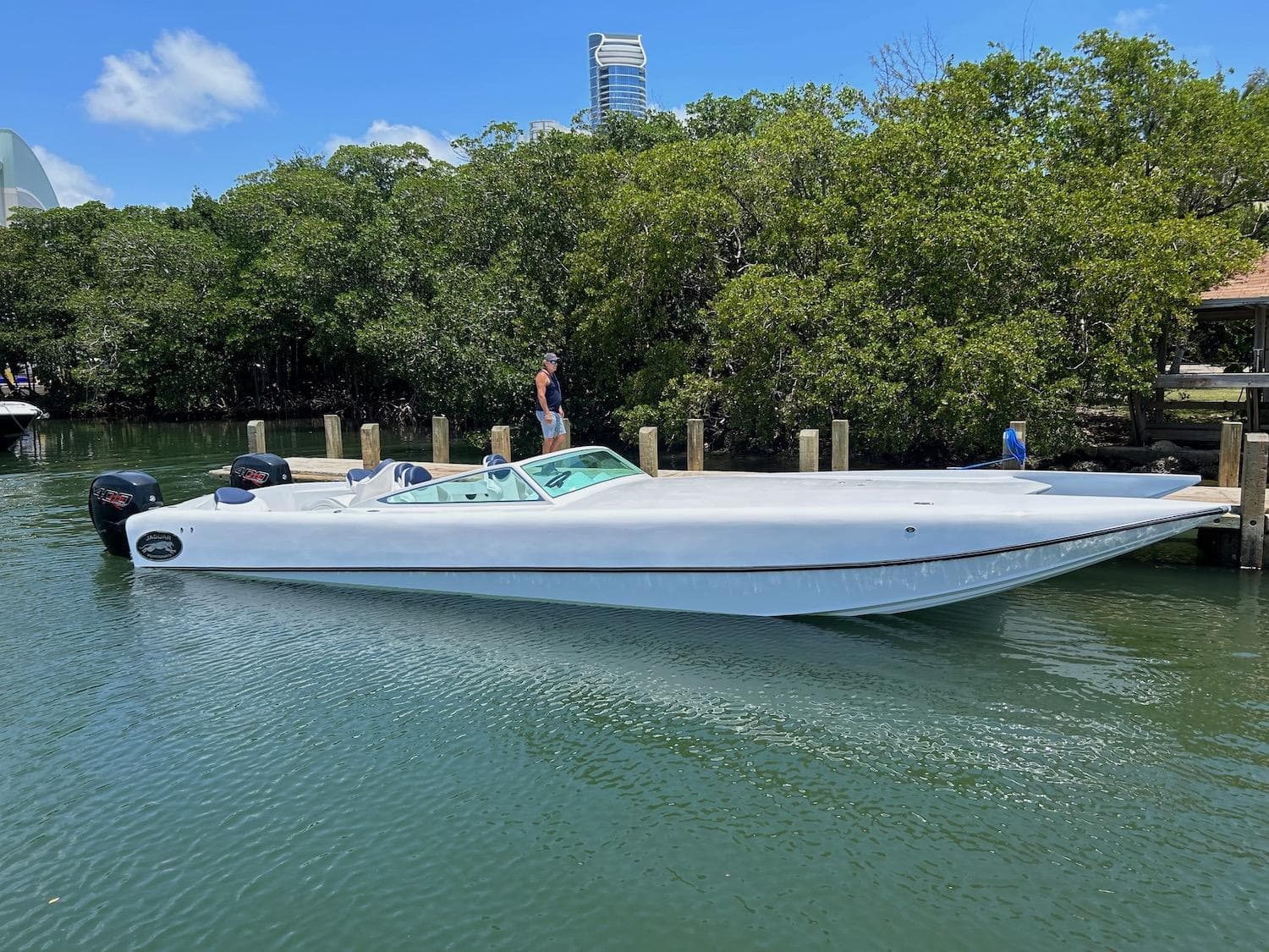 2024 Jaguar 37 Wildcat speedboat docked in a serene marina.