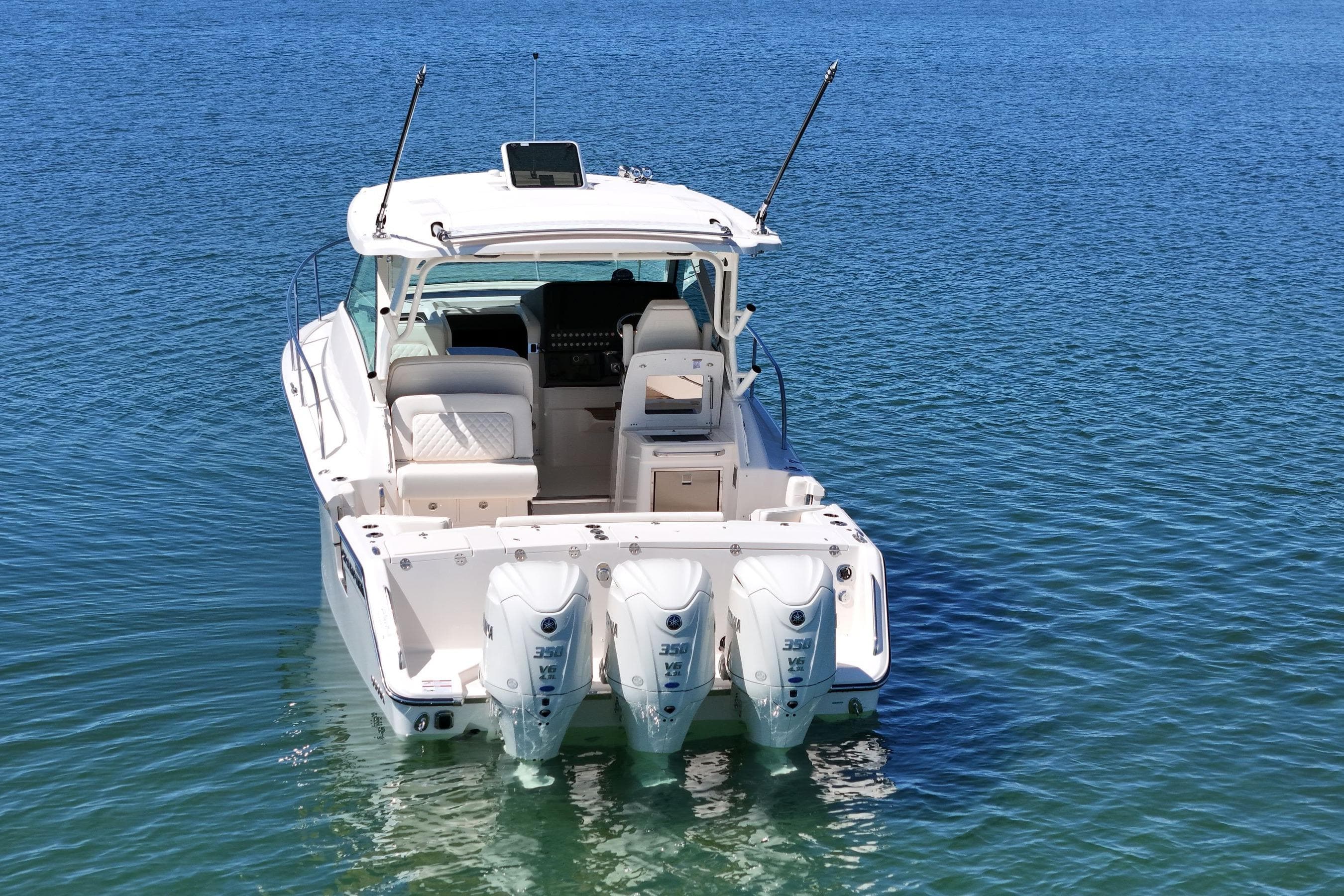 2026 Grady-White Express 340 boat with triple engines on calm blue water.