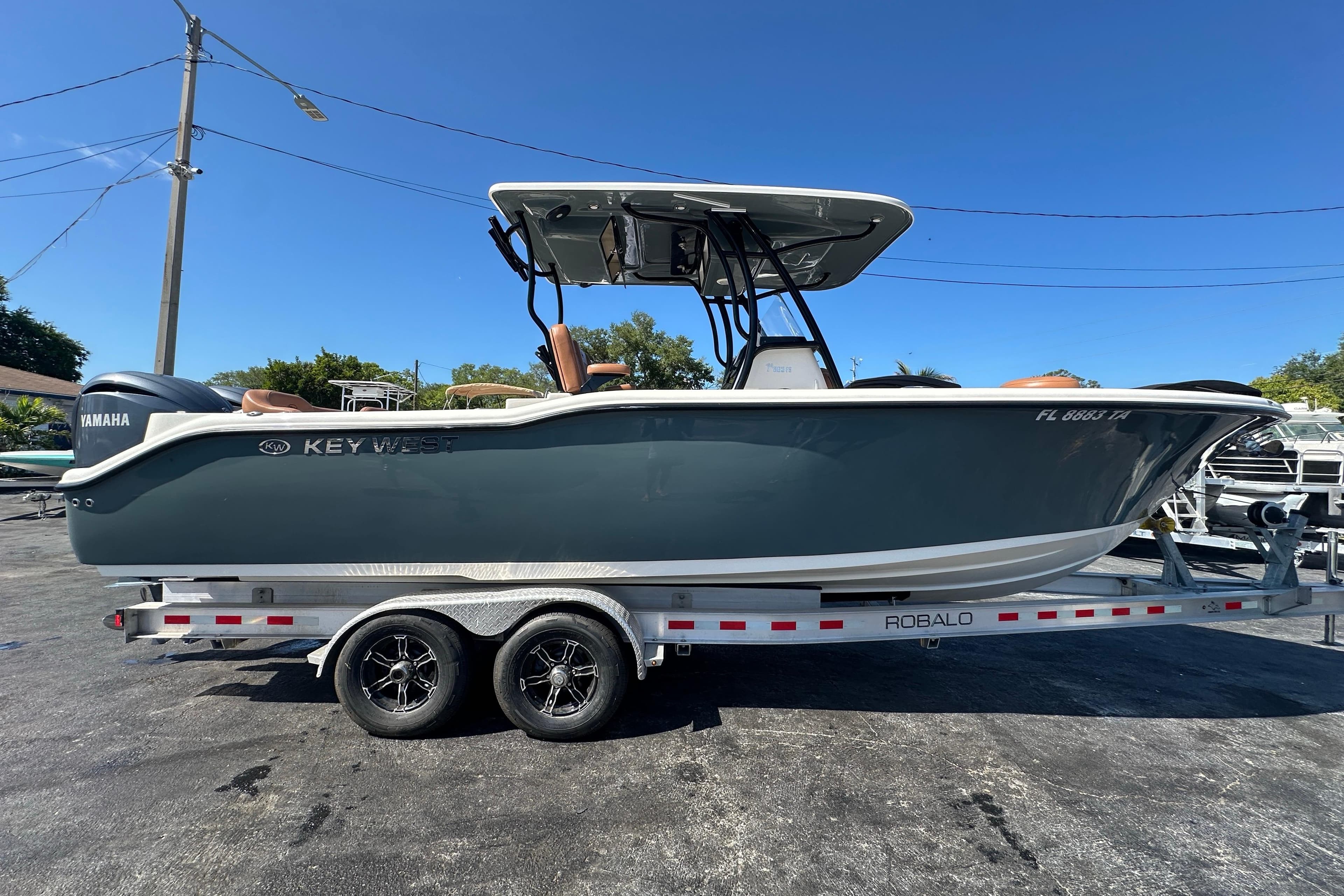 2021 Key West 263 FS boat on trailer, side view under clear blue sky.