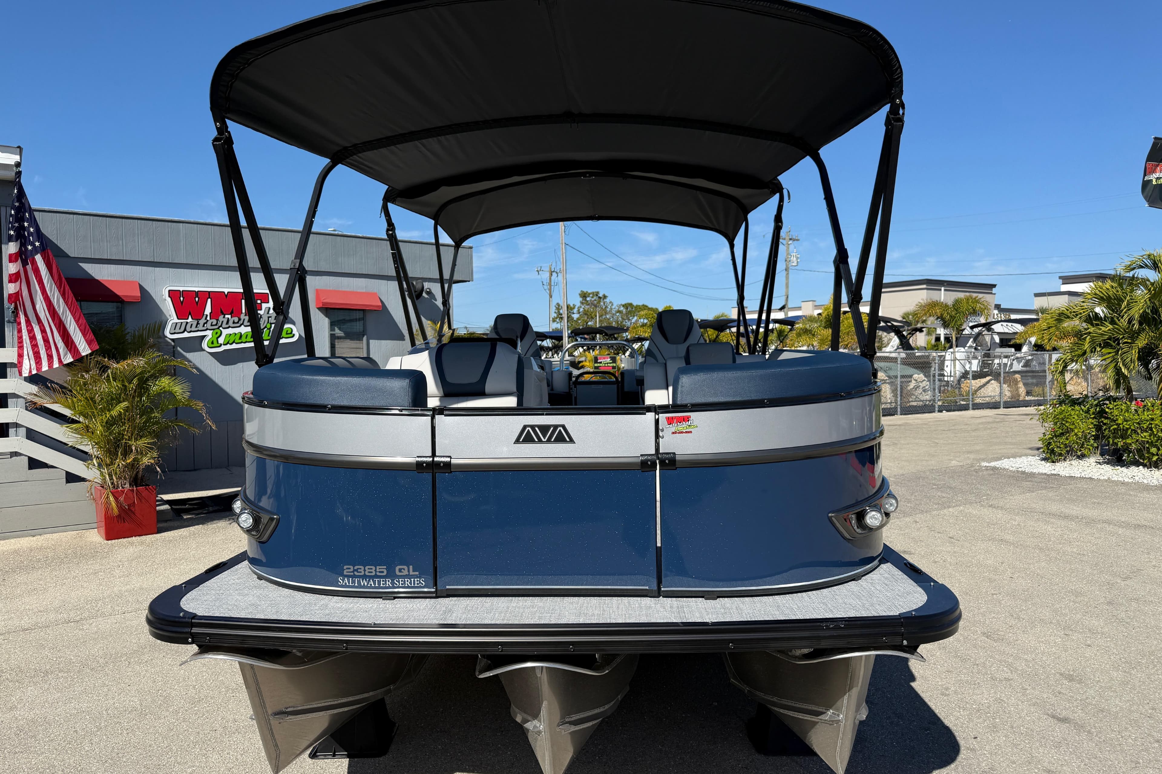 2026 Avalon 2385 Catalina Quad Lounger Tri Toon boat, parked outdoors with canopy.