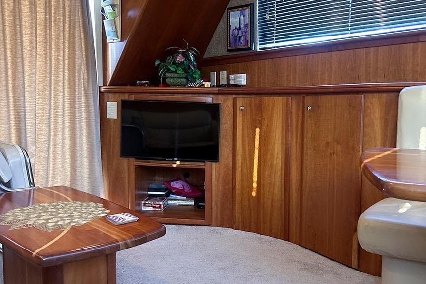 Luxurious interior of 2002 Silverton 42 Convertible yacht with wood paneling and modern amenities.