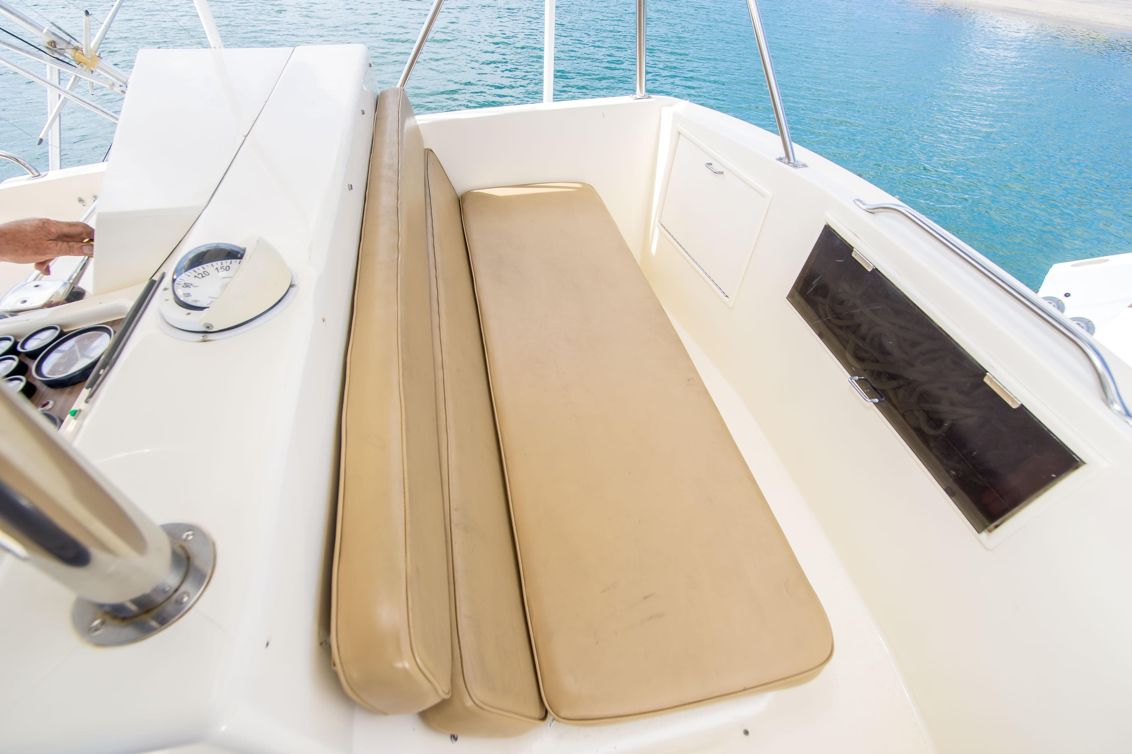 1986 Ocean Yachts 48 Super Sport cockpit with beige seating and control panel.