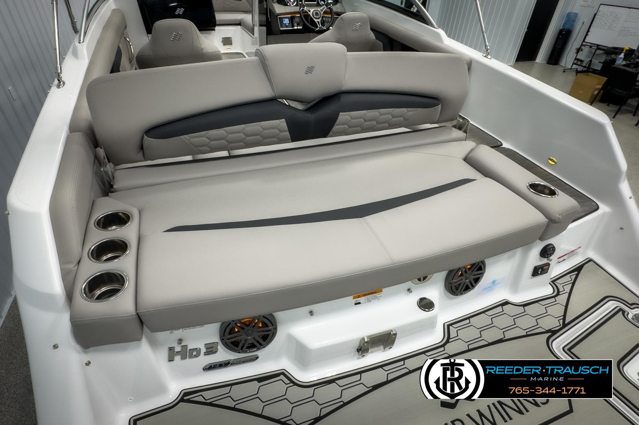 2025 Four Winns HD3 boat interior with cushioned seating and cup holders.