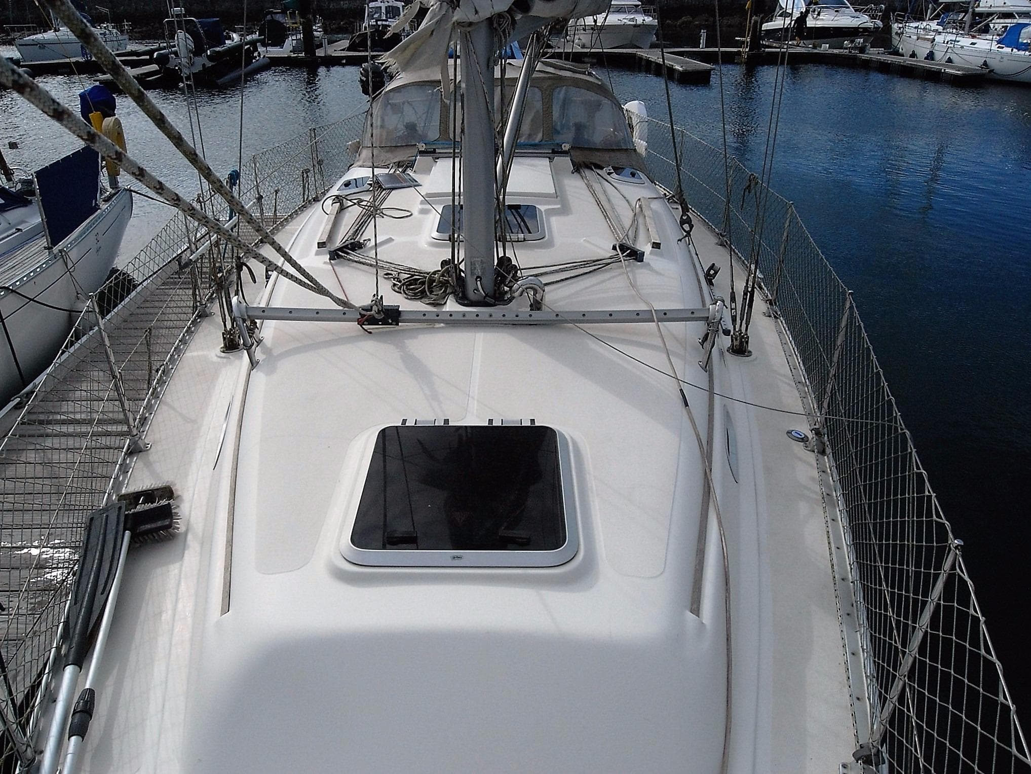 Deck of a 2003 Hanse 341 sailboat in a marina.