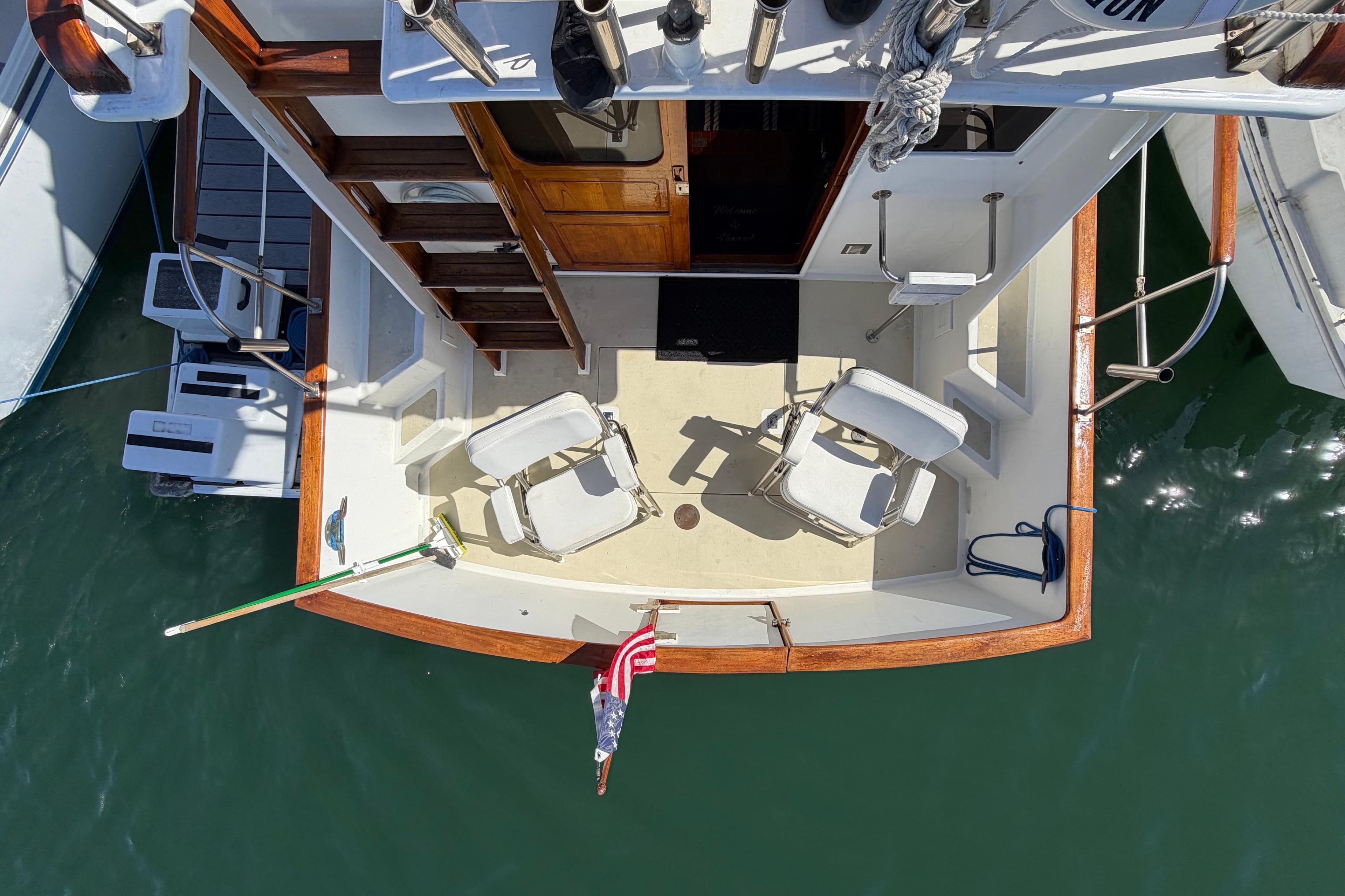 Aerial view of 1982 Lien Hwa 31 boat deck with chairs and American flag.