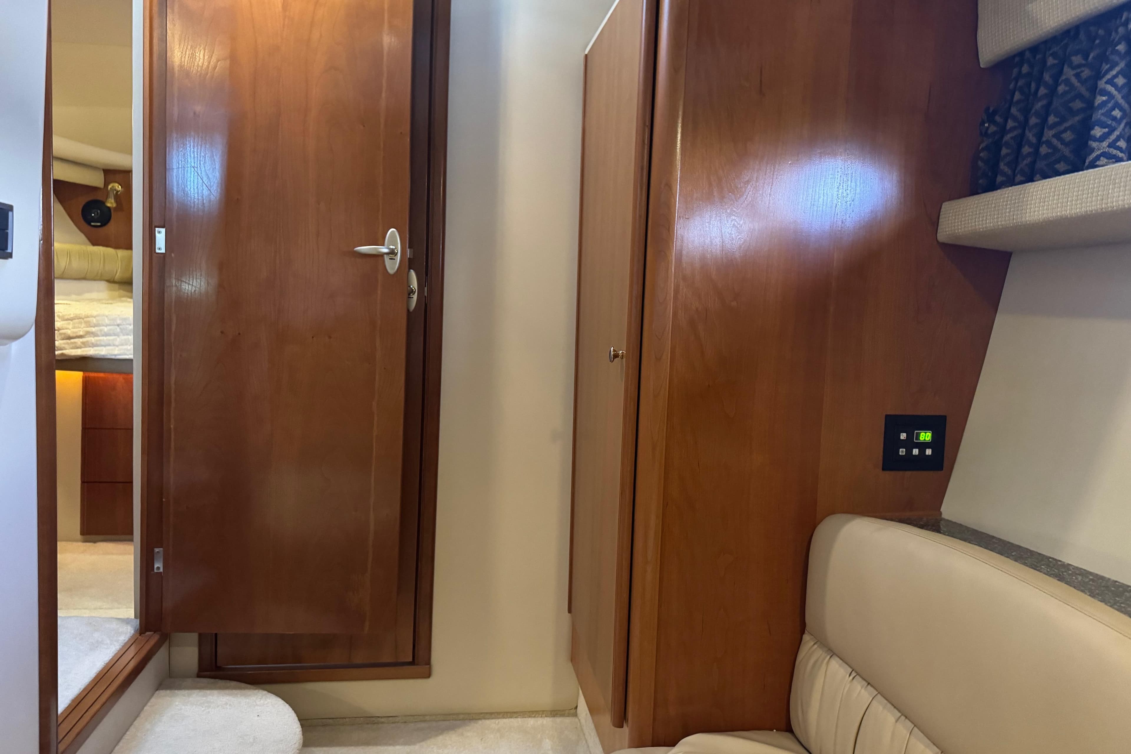 Interior of a 2003 Meridian 411 Sedan yacht, featuring wooden cabinetry and beige seating.