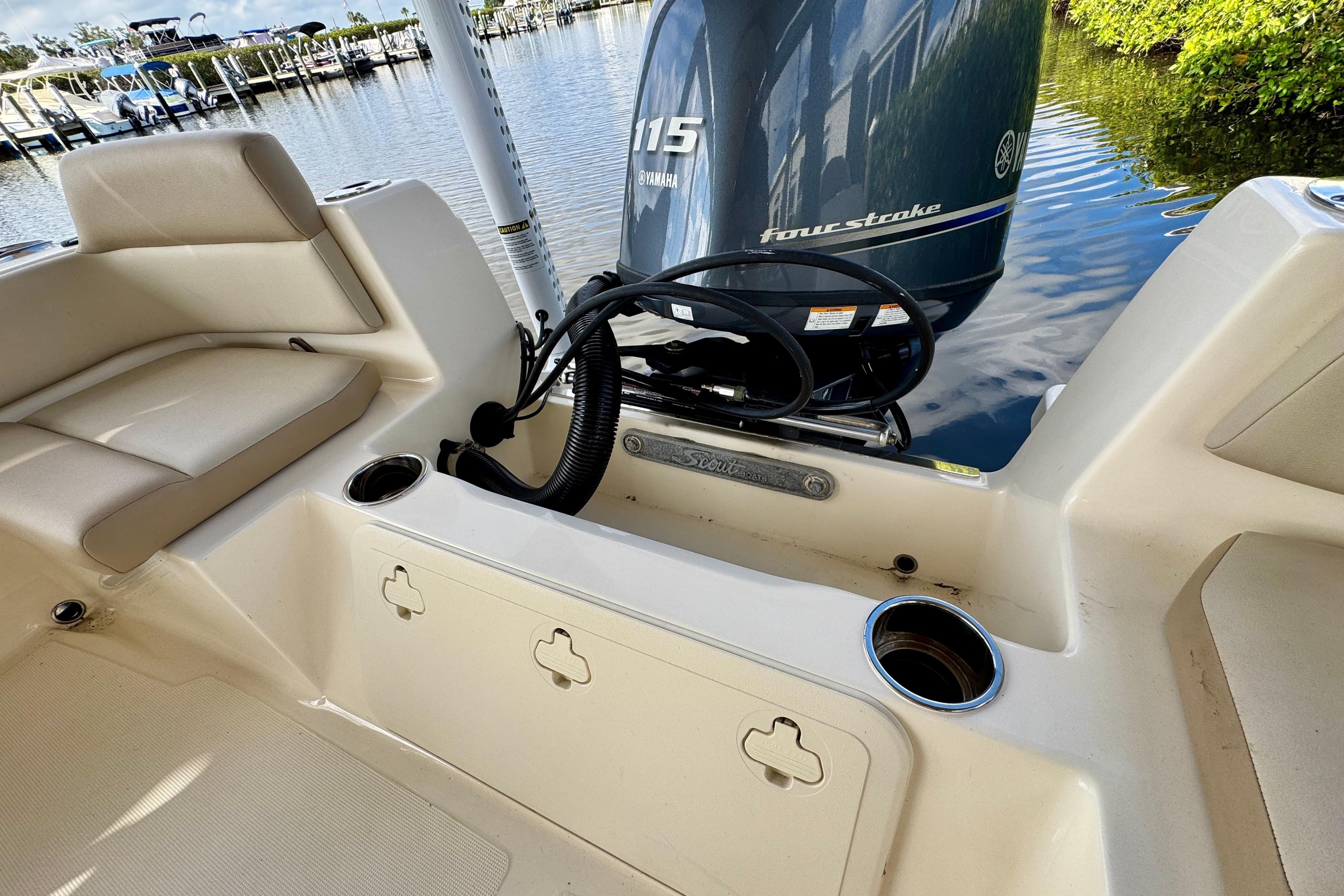 2024 Scout 195 Sportfish boat interior with Yamaha 115 four-stroke engine at dock.