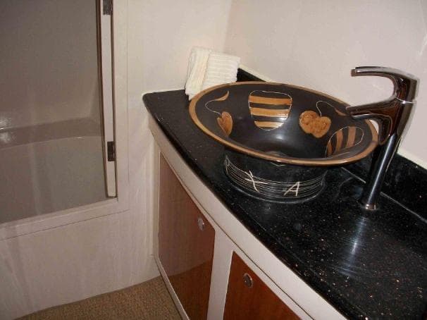 Elegant bathroom sink with artistic bowl design on Prout 45S, 2009 model yacht.