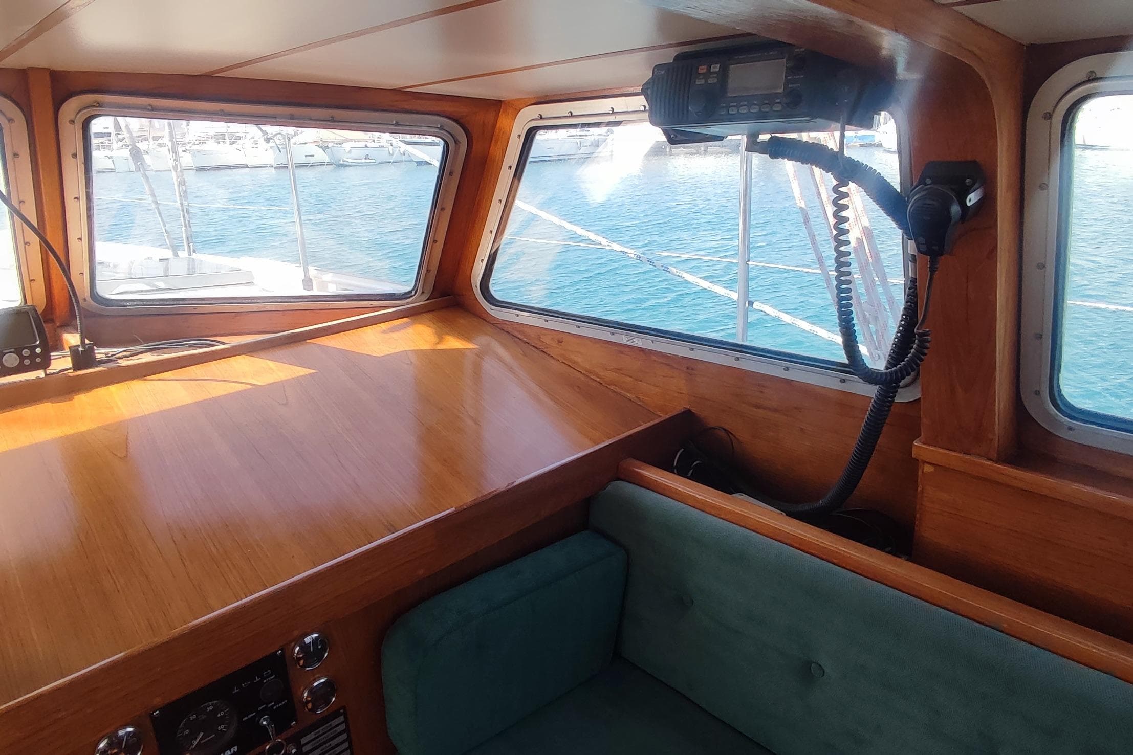 Interior of 1987 Custom Danish 44 boat with wooden finish and ocean view.