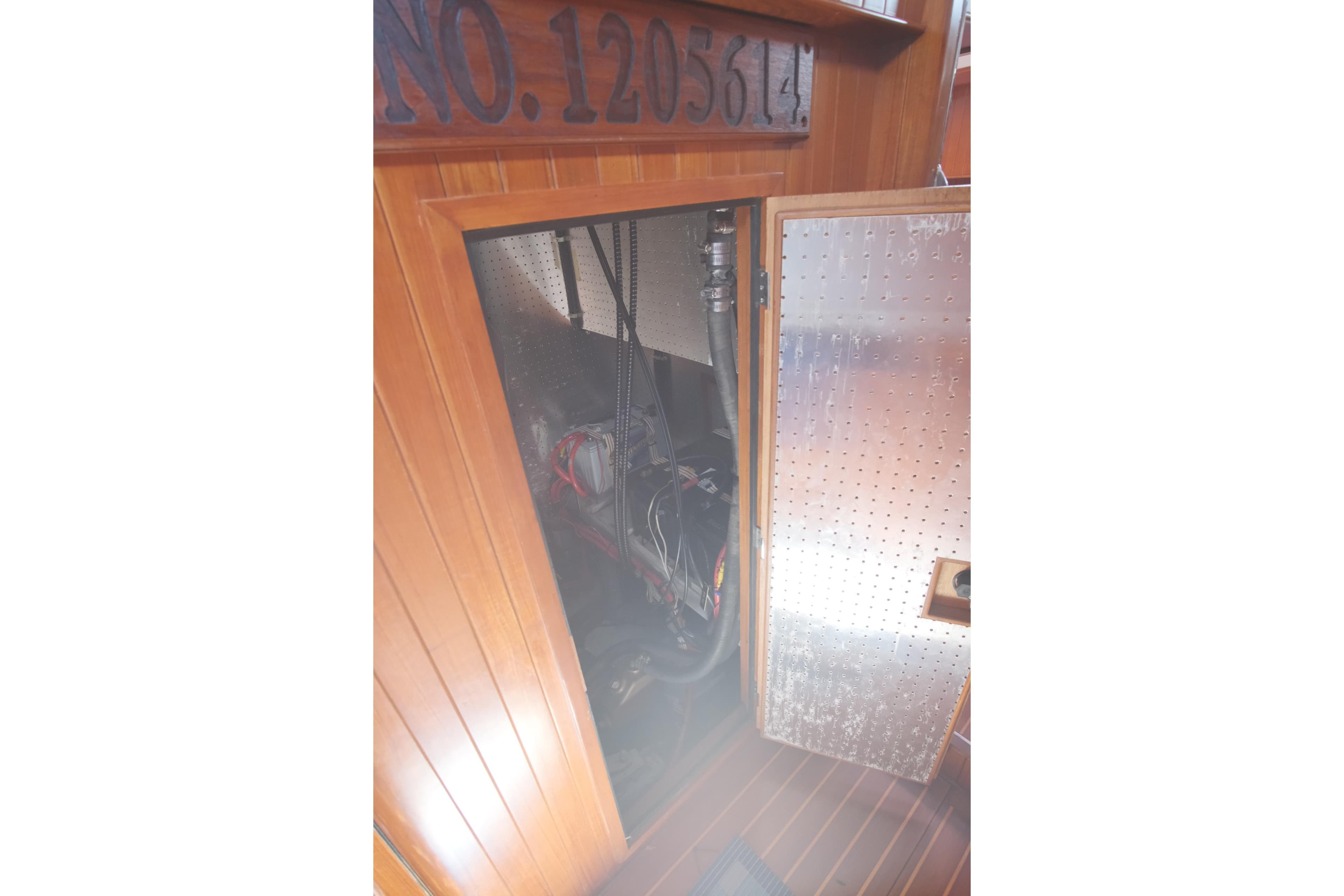 Engine compartment of 2006 Tayana Vancouver 42 sailboat with wooden interior paneling.